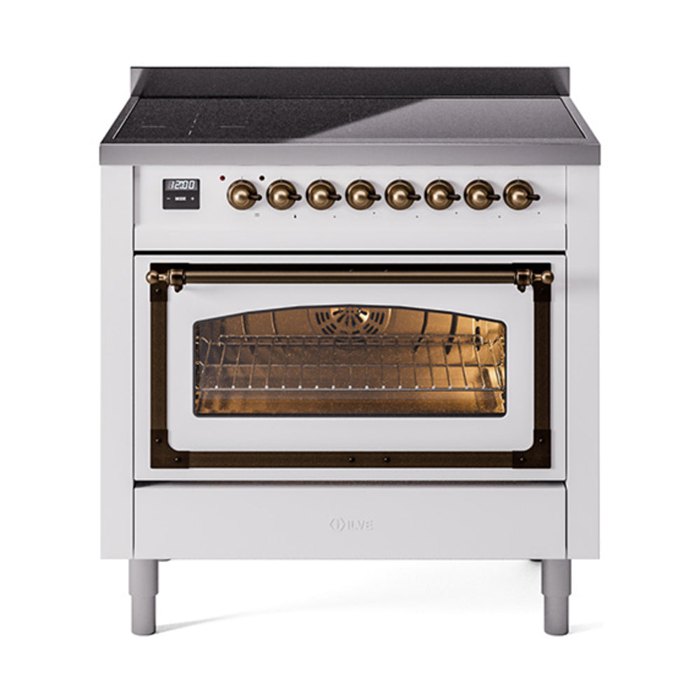 White induction range with bronze knobs and open oven door, amber interior