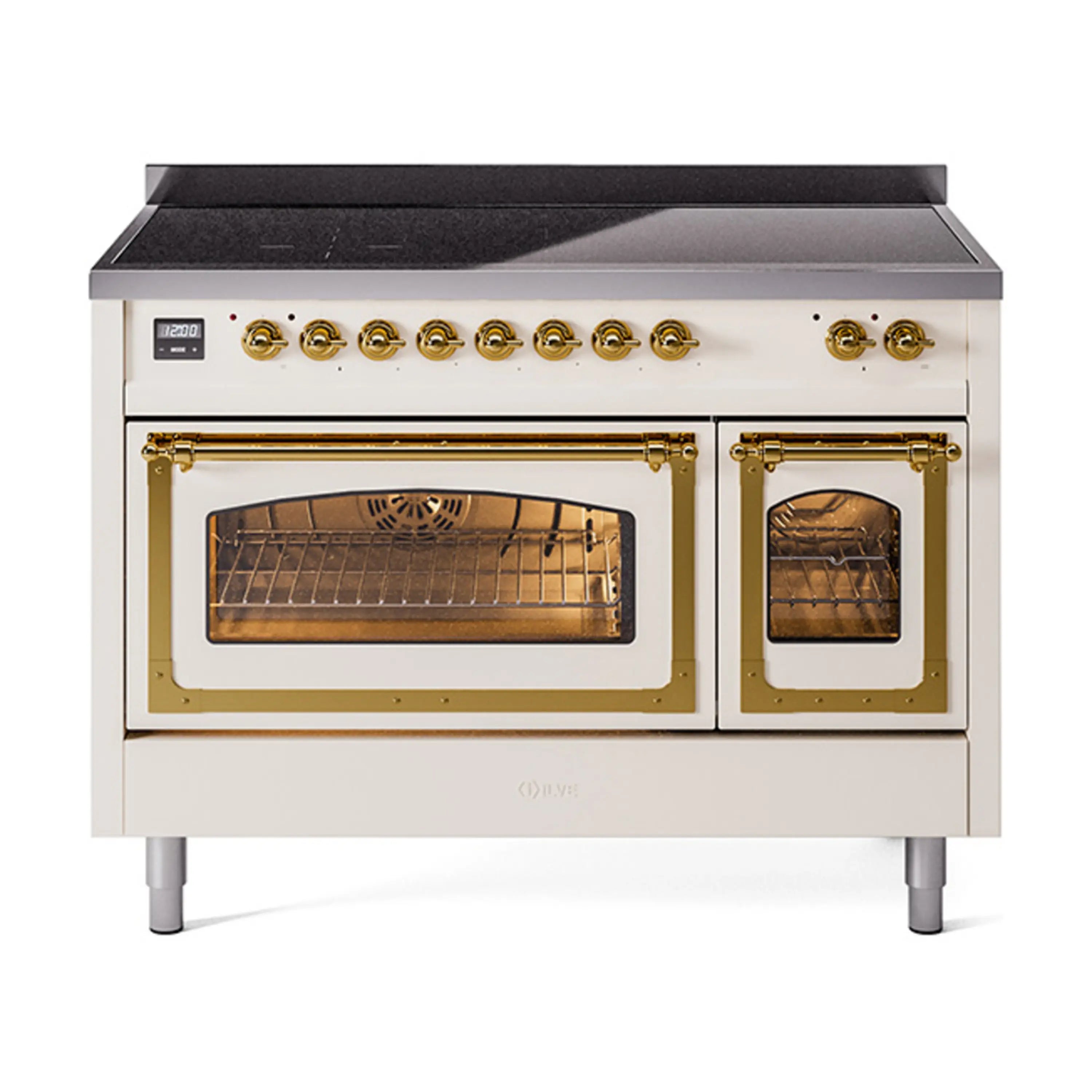 Antique white induction range with brass trim, open main and side oven doors.
