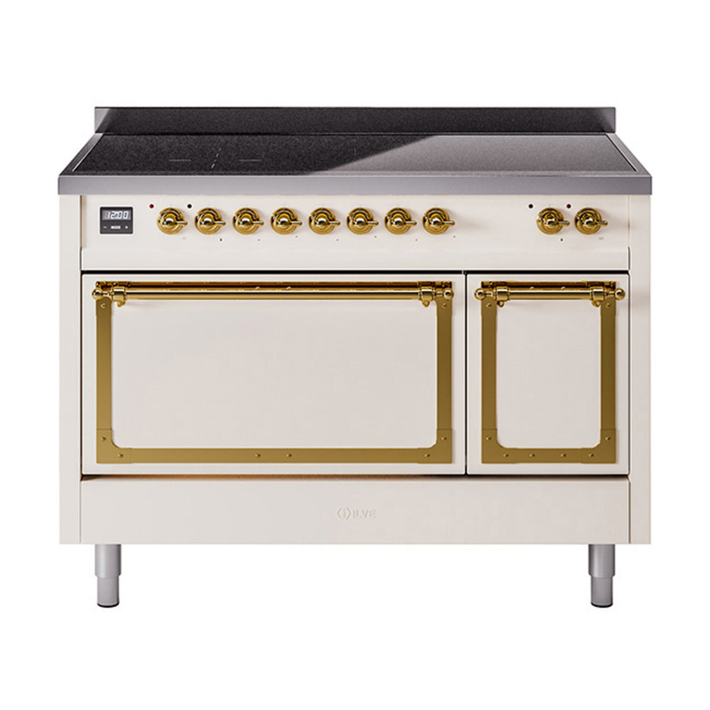 Antique white induction range with brass-trim ovens, cooktop, and black glass top