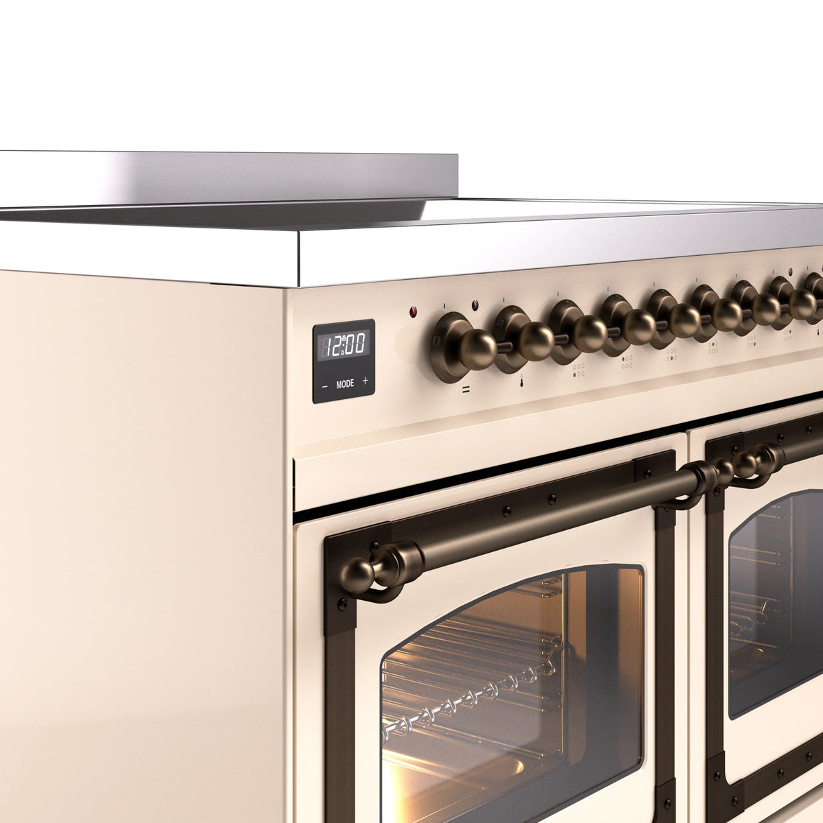 Antique white induction range control panel with bronze knobs above an oven door