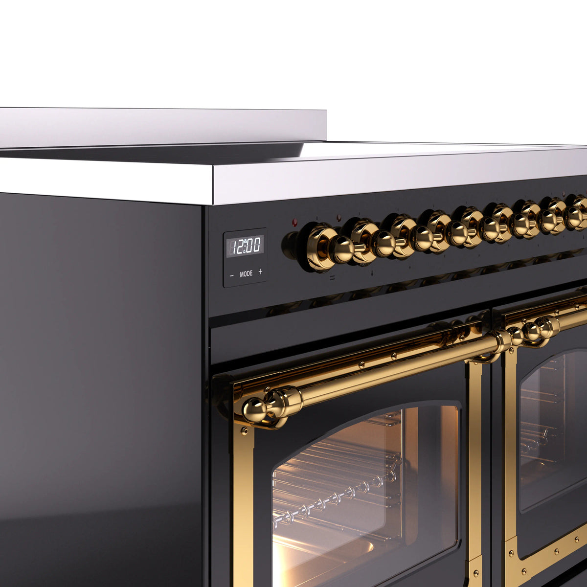 Glossy black range control panel with brass knobs and brass oven door handle detail