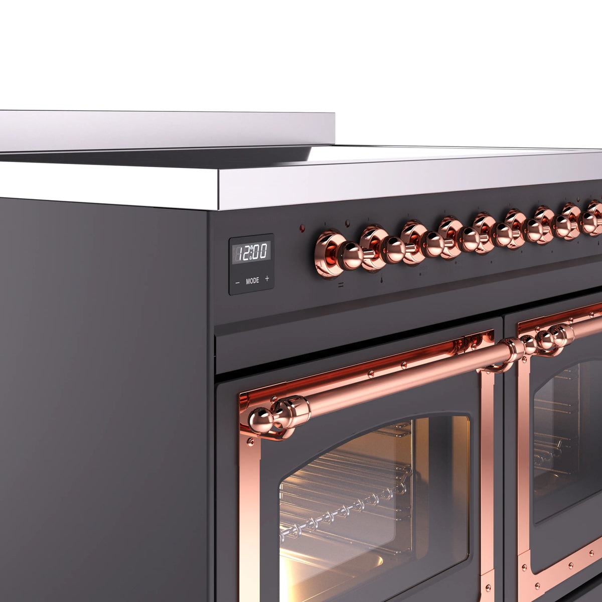 Close-up of copper control knobs and oven door frame on matte graphite induction range