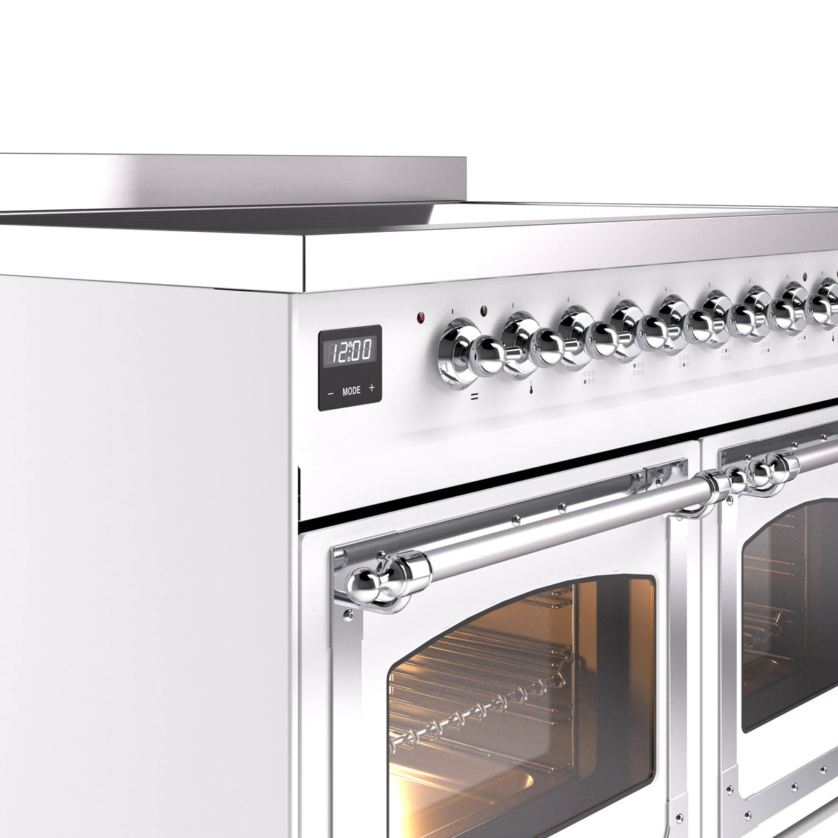 Chrome control knobs and display on white induction range beside open oven door