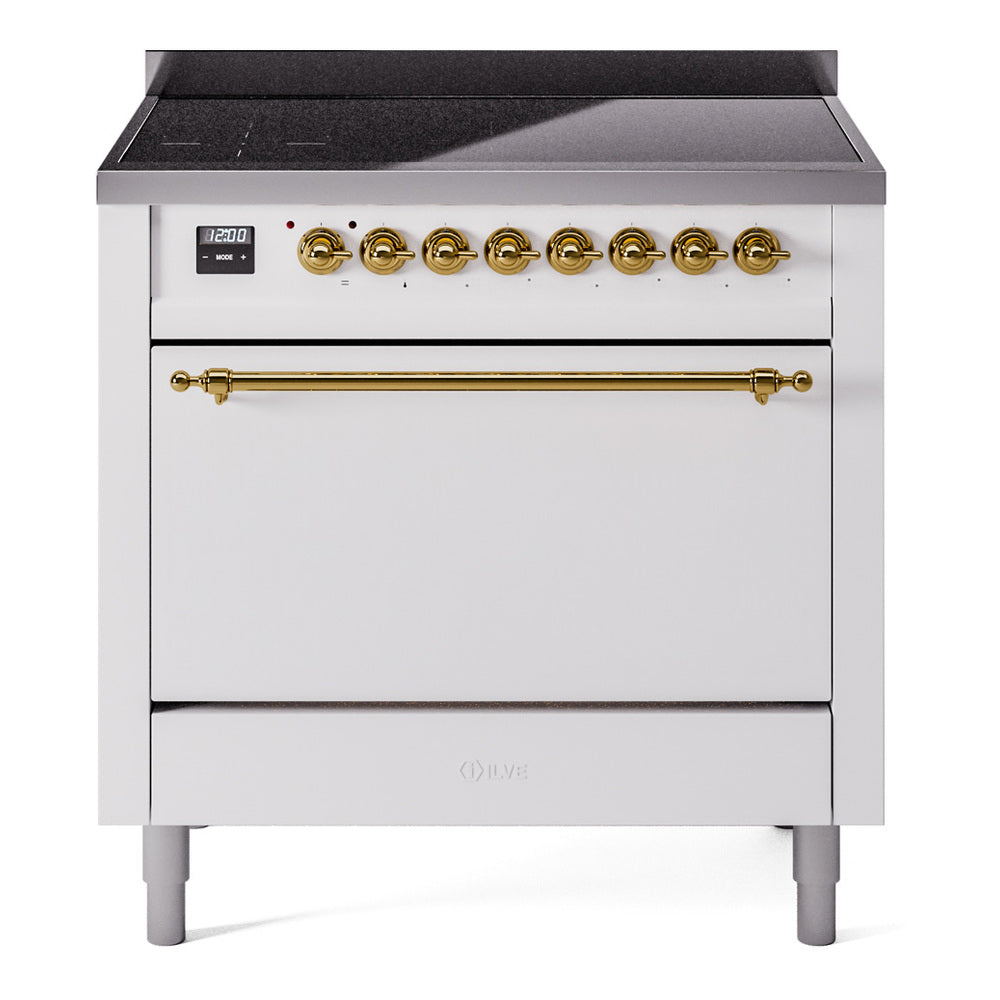 White induction range with brass control knobs, cooktop, and closed oven door