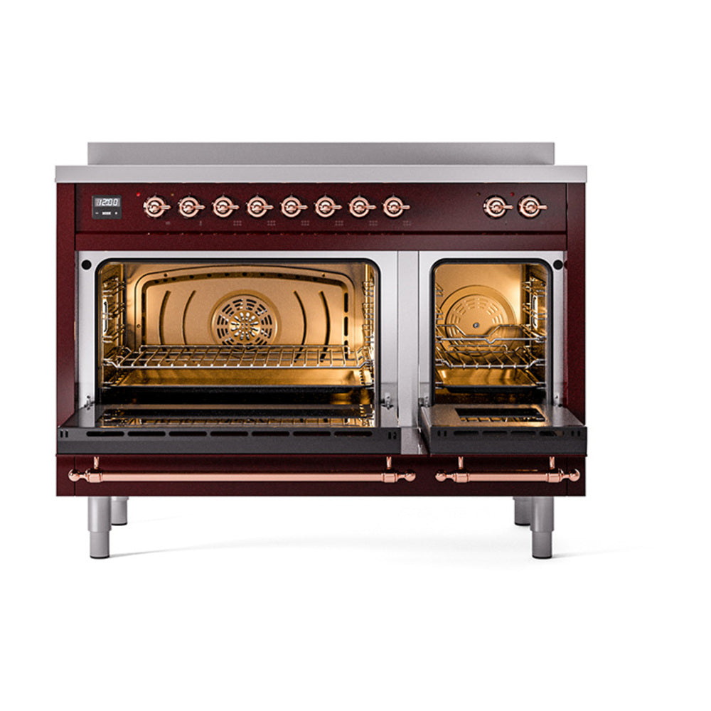 Burgundy induction range with open ovens showing interior racks and warm lighting