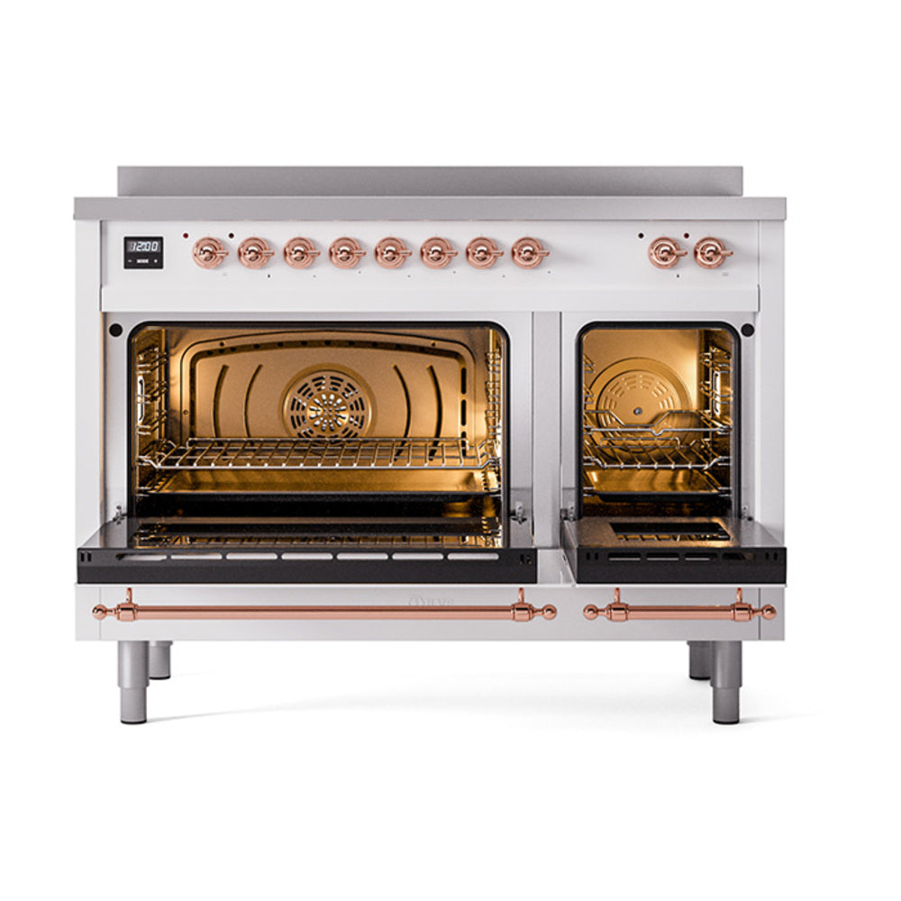 Induction range with two open ovens showing racks, warm interior, and copper control bar