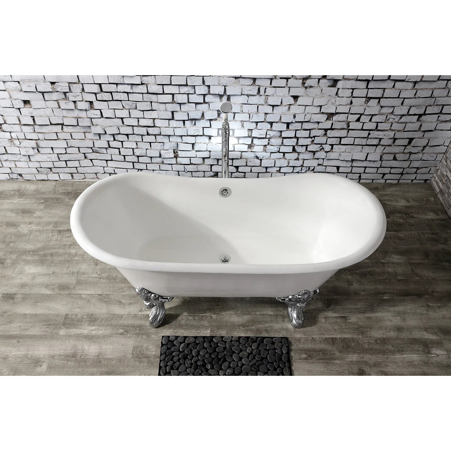 White oval clawfoot cast iron bathtub with polished chrome feet and drain opening