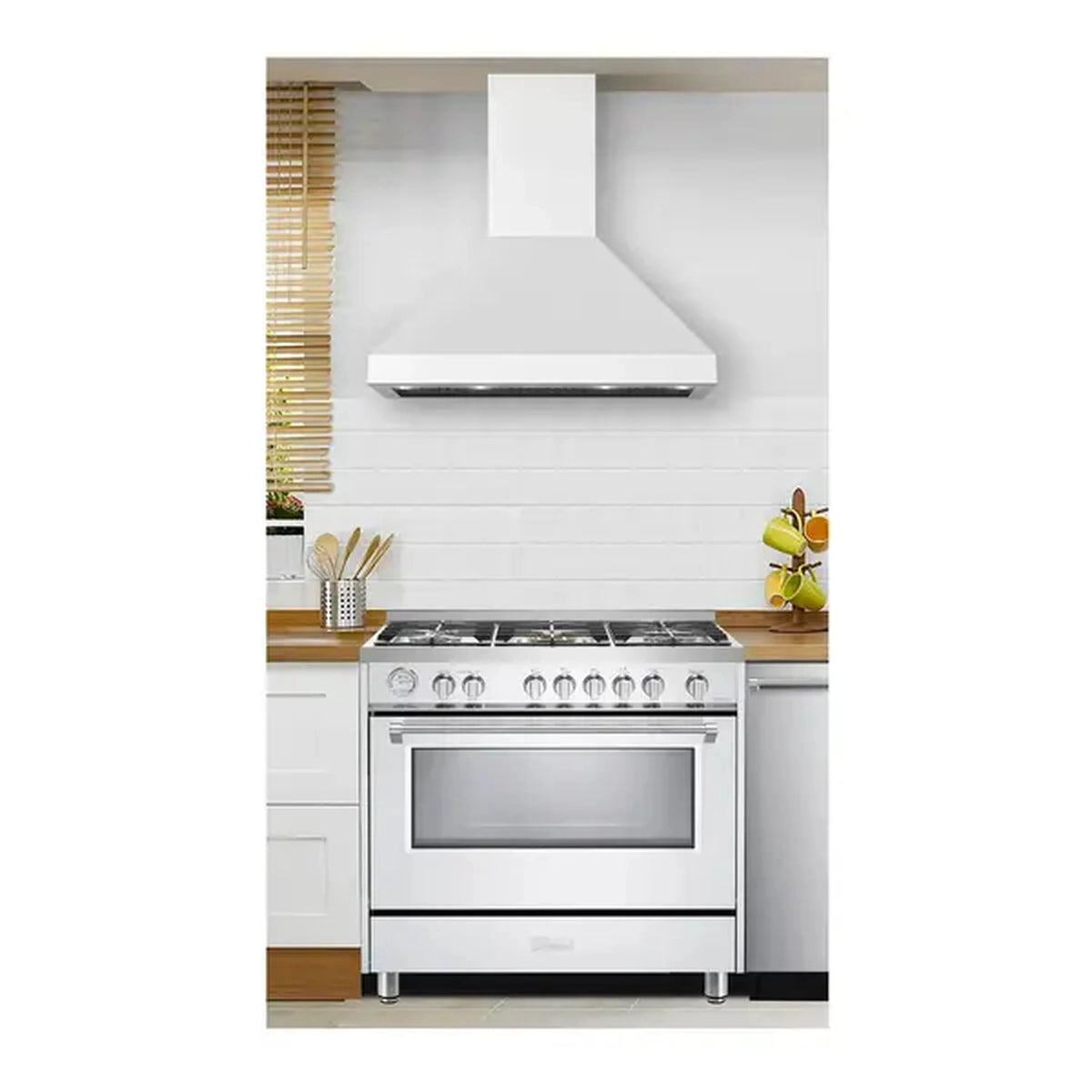 White freestanding gas range with wall hood above, front control knobs and burners