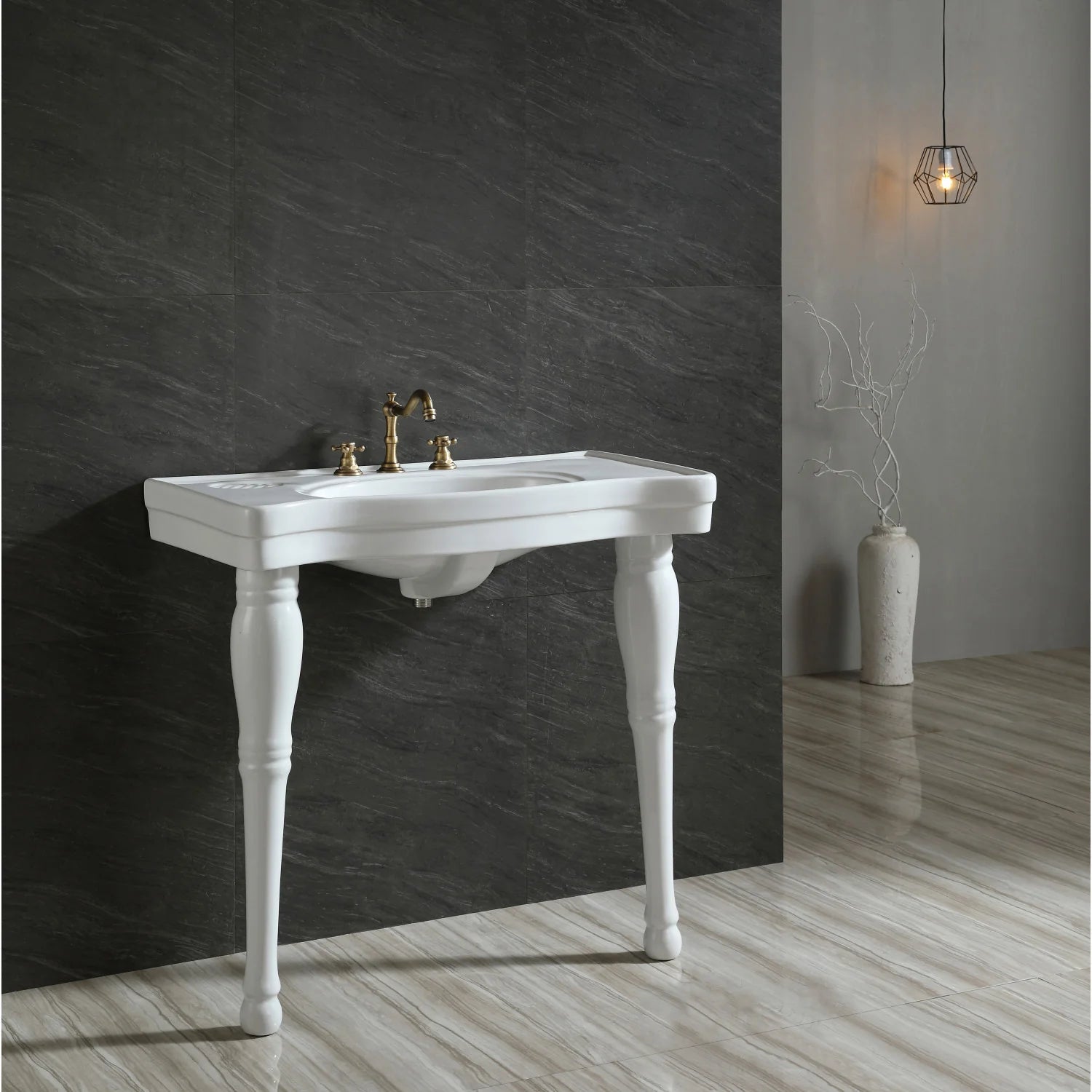 White ceramic console sink with legs and gold faucet handles, single oval basin