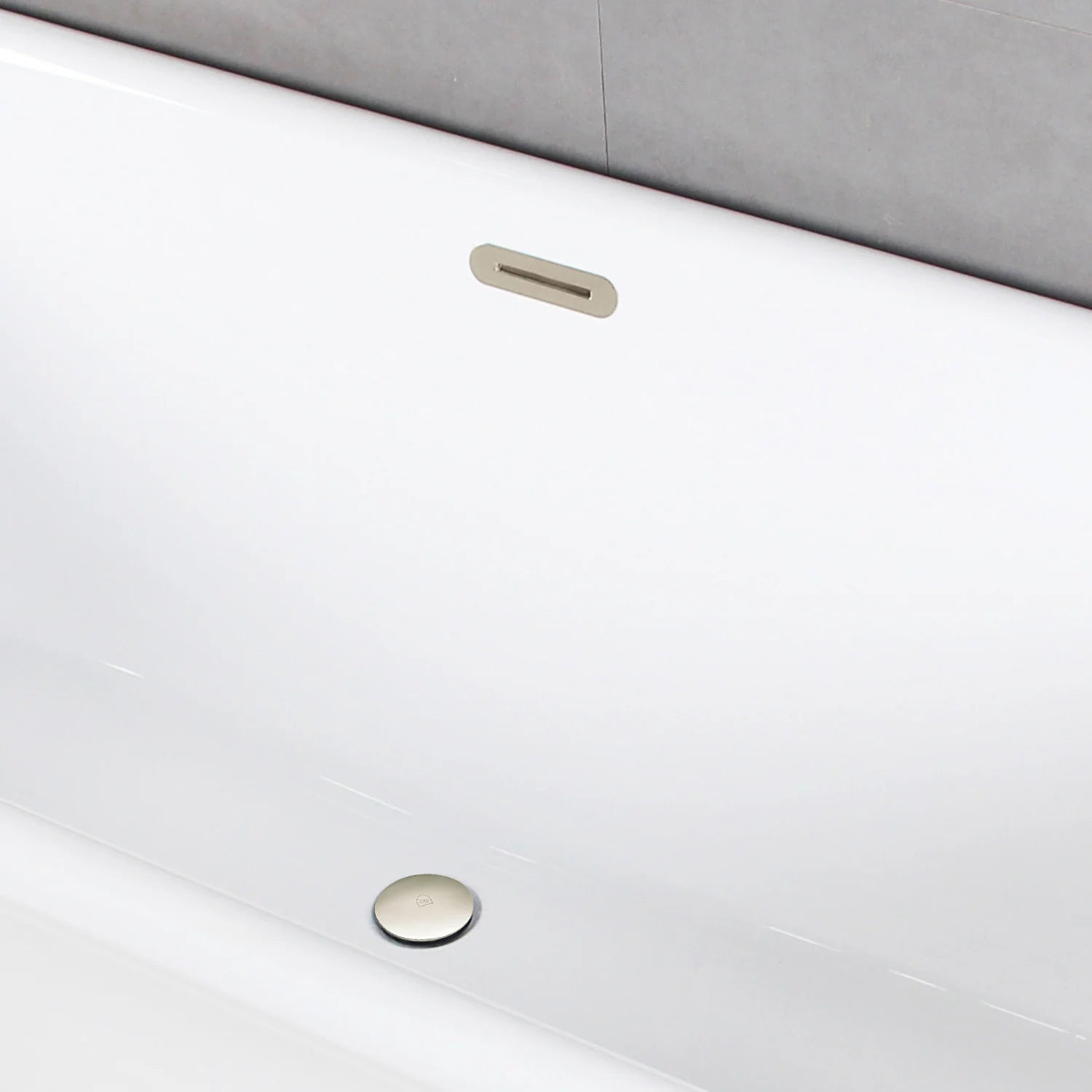 Glossy white acrylic tub with polished nickel drain and overflow slot