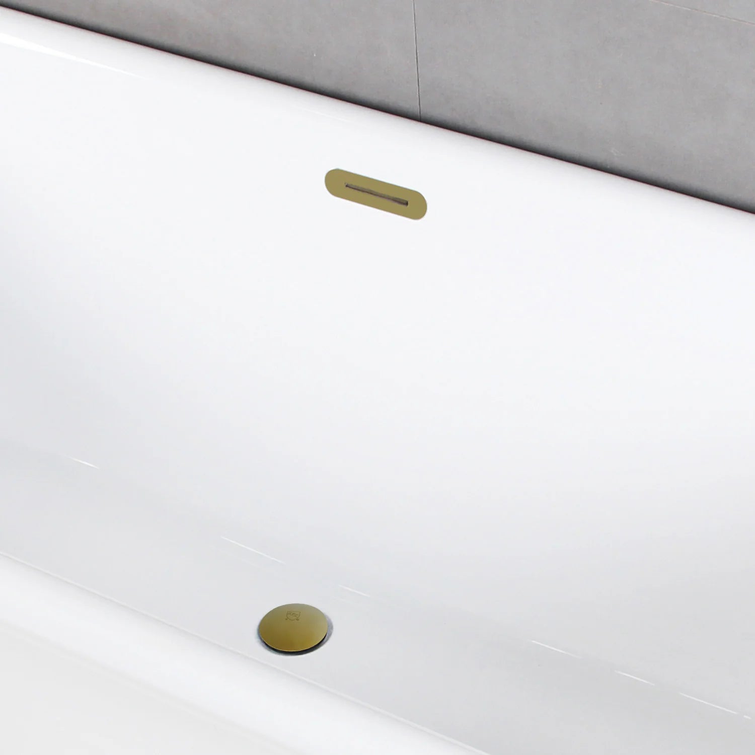 Glossy white oval acrylic tub with brushed brass drain and overflow