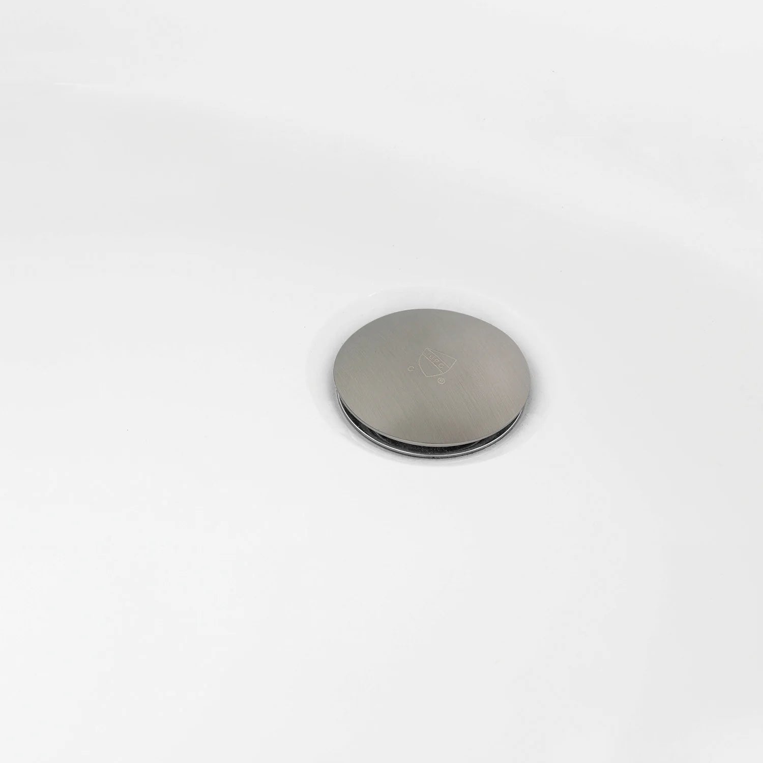 Glossy white tub with brushed-nickel round drain cover