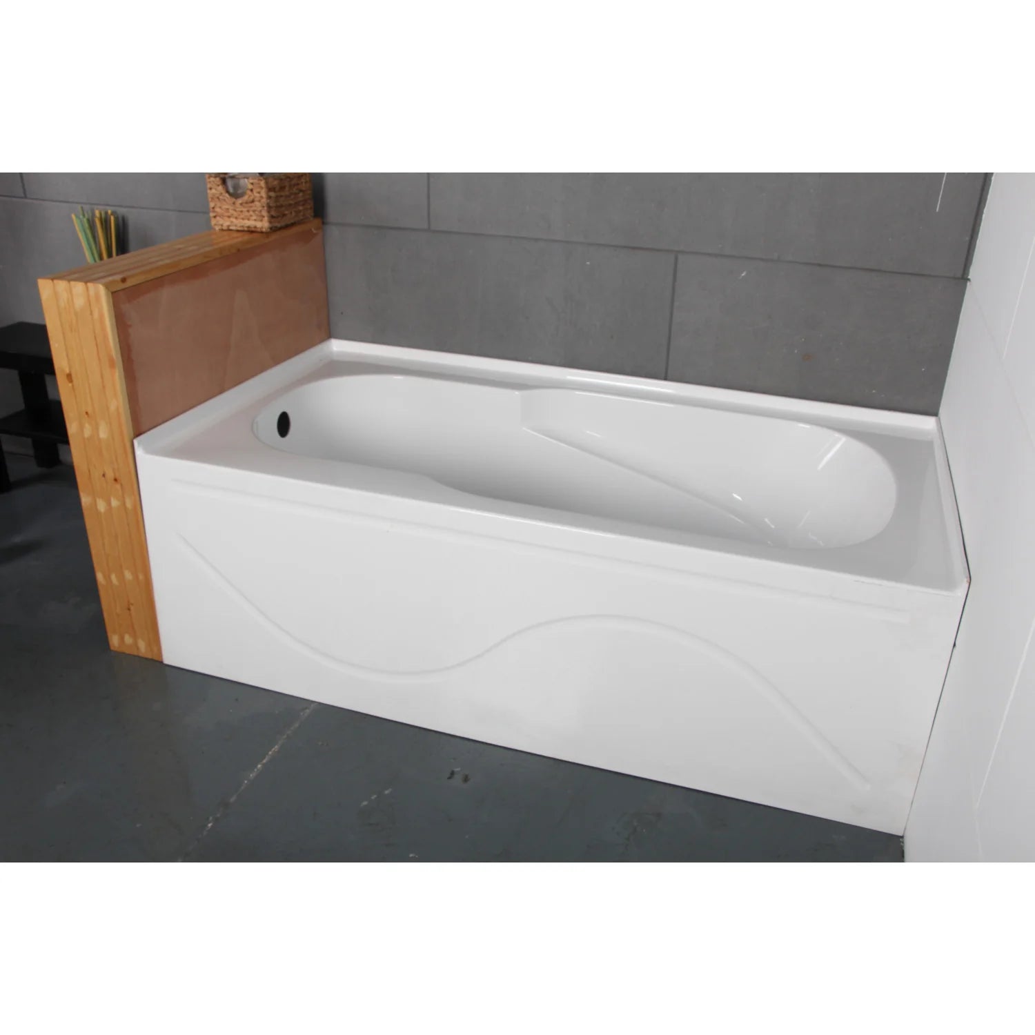 Glossy white acrylic rectangular alcove tub installed in a wall alcove