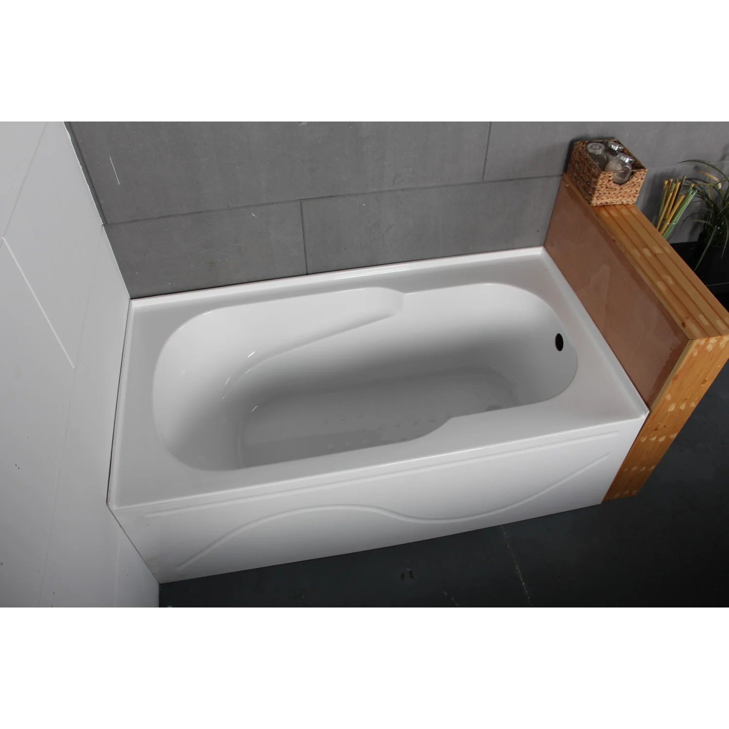 Installed glossy white acrylic rectangular alcove bathtub with right-hand drain and smooth interior