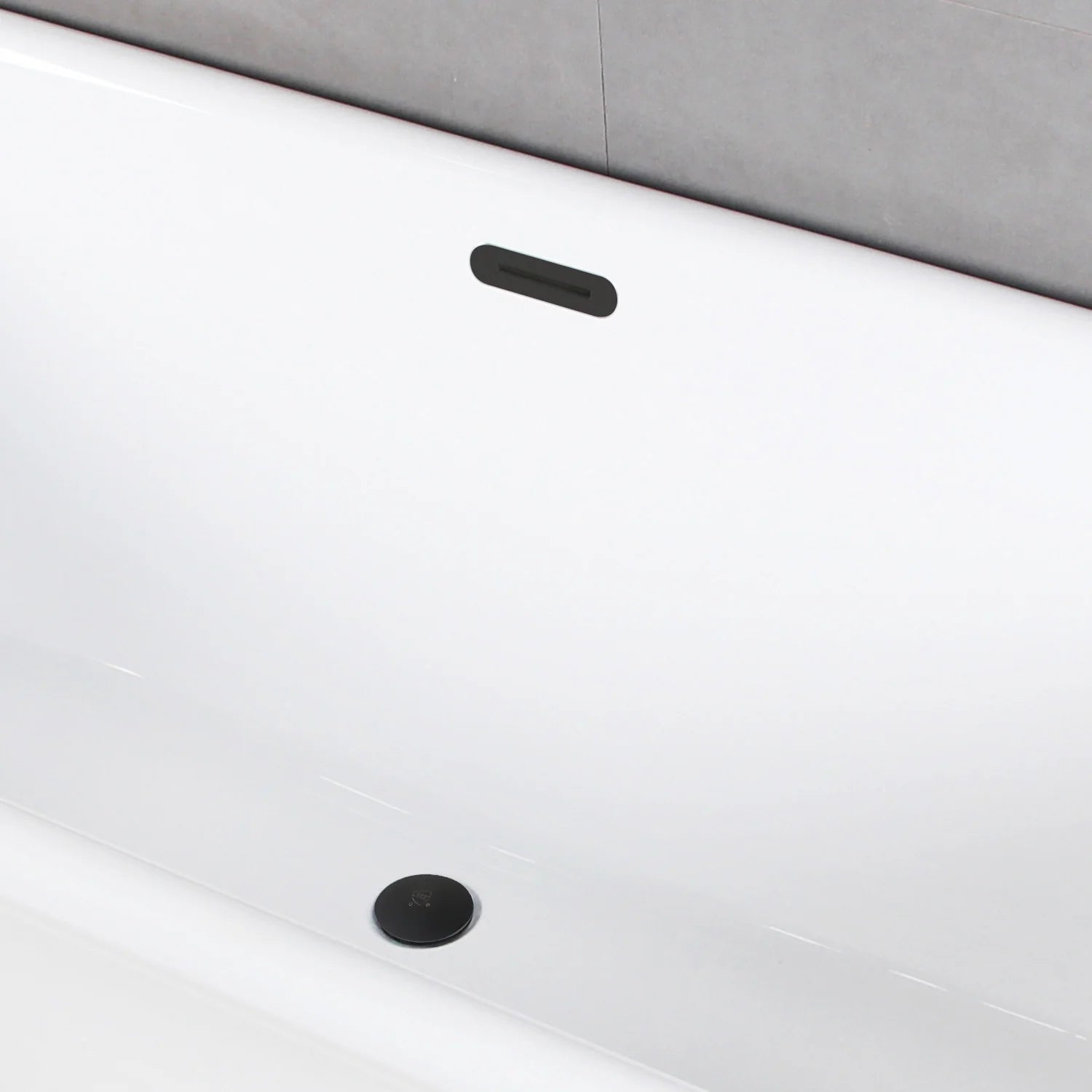Glossy white oval acrylic bathtub with matte black drain cover