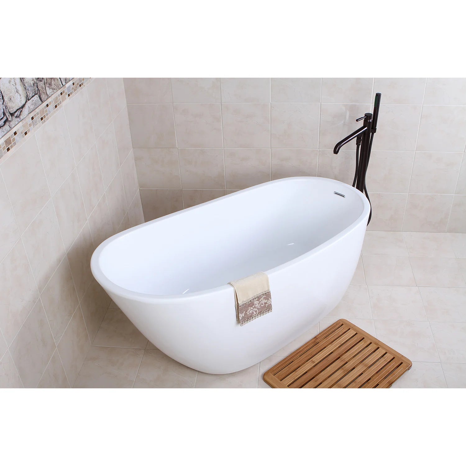 Glossy white oval freestanding acrylic bathtub with faucet and towel on rim