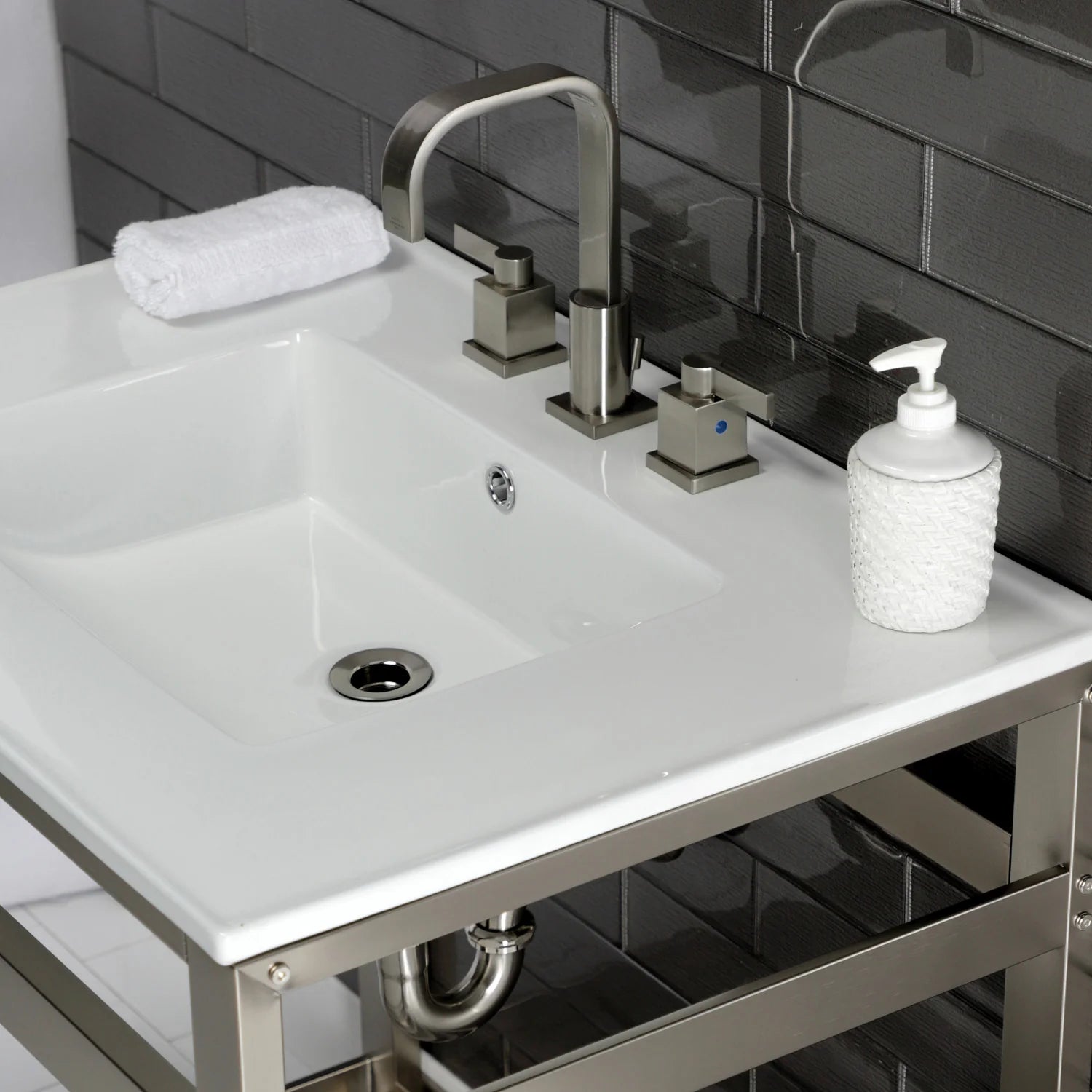 White ceramic sink with brushed nickel faucet, 3-hole deck, and soap dispenser