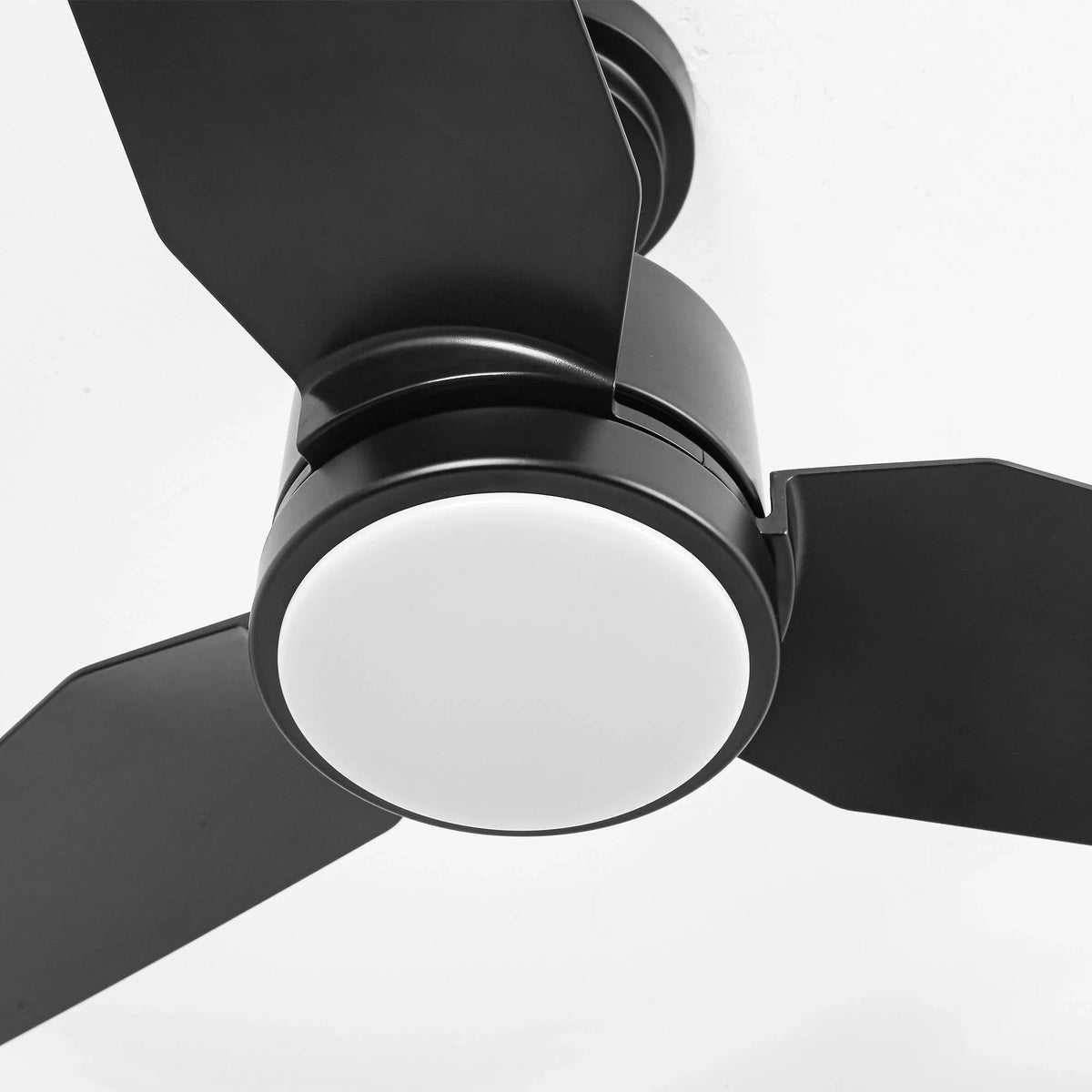 Close-up of black ceiling fan LED light ring under a blade