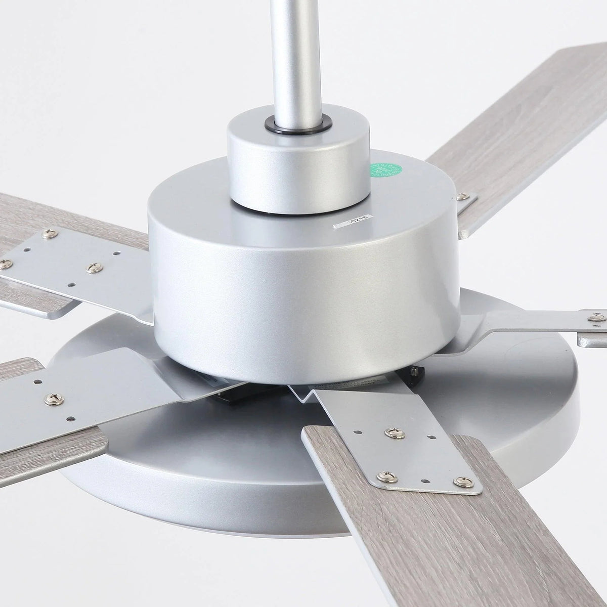 Silver ceiling fan motor base with five blades and frosted LED light dome