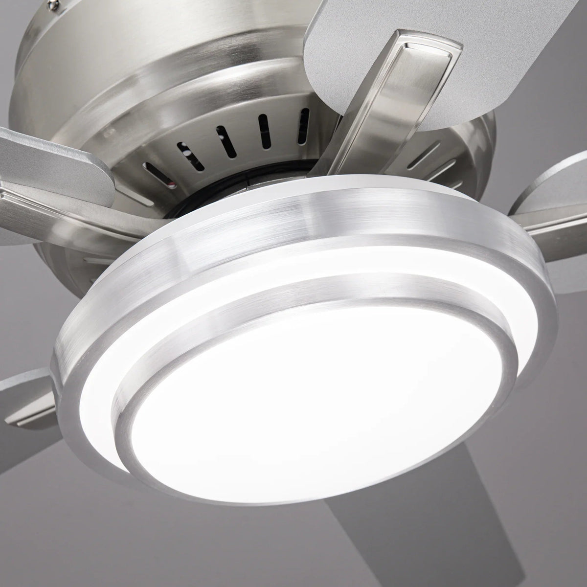 Frosted flush LED light under satin nickel ceiling fan housing, with glowing light