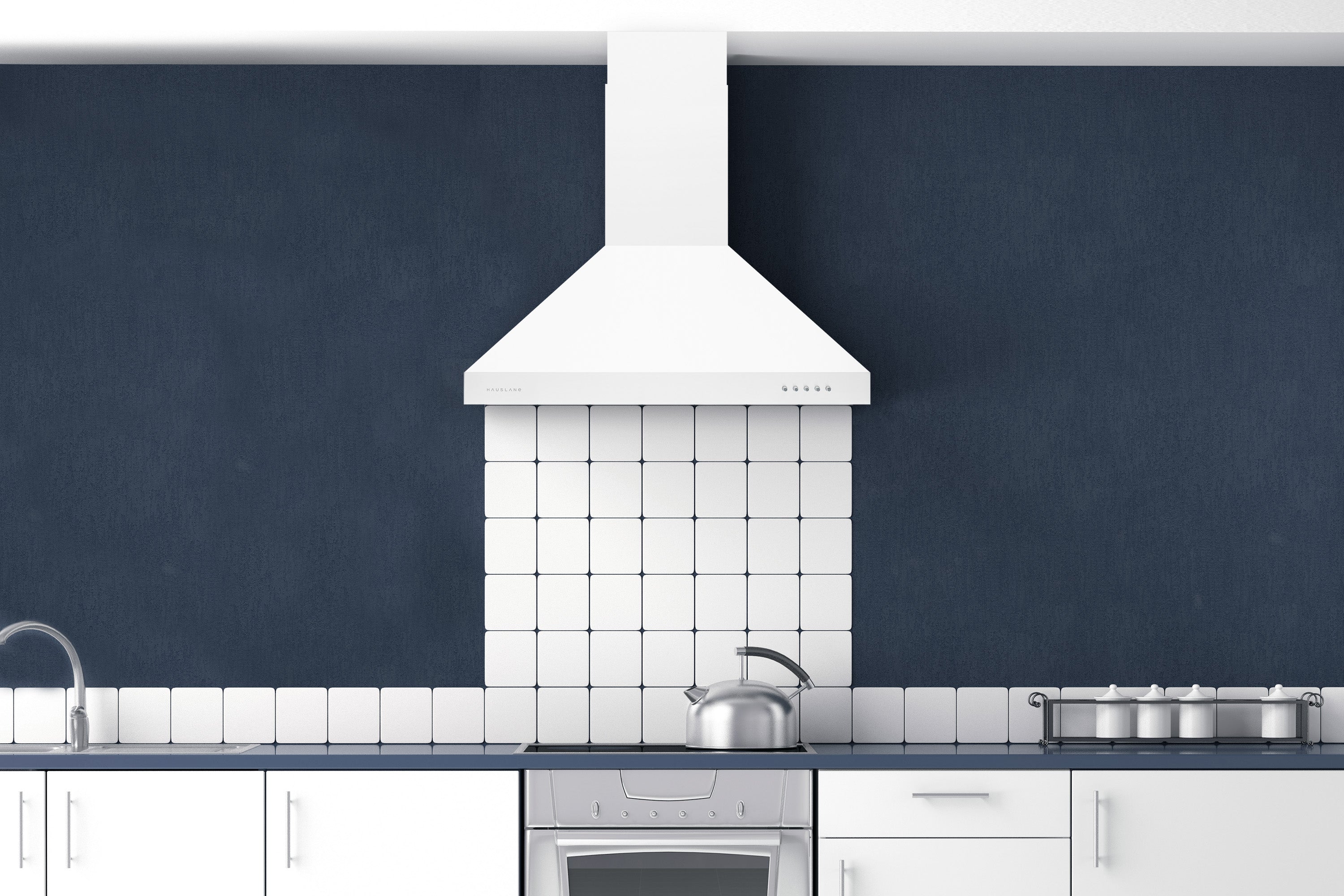 Matte white range hood over a stove in a kitchen, with chimney and vent