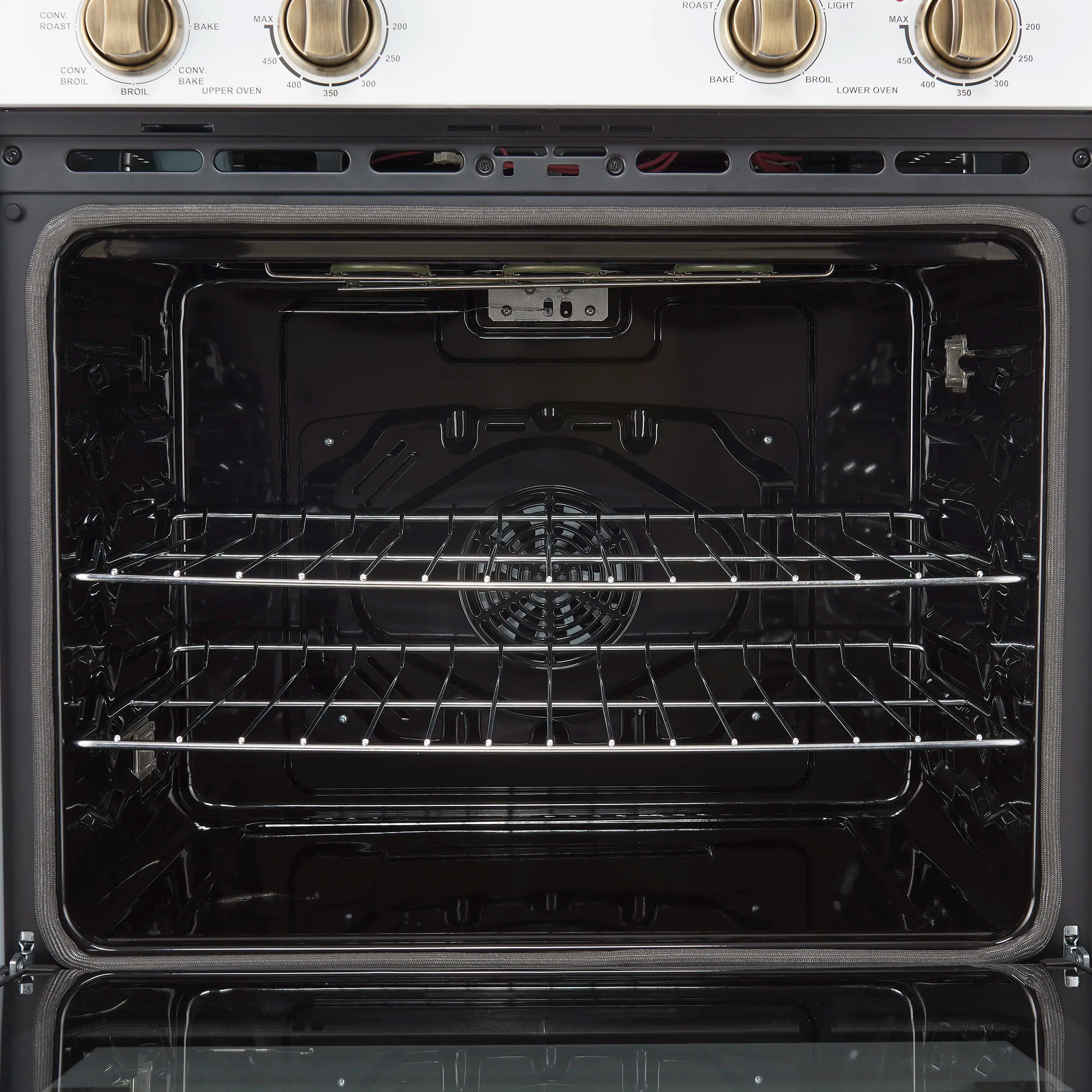 Lower oven interior with dark cavity, chrome wire rack, and back heating elements
