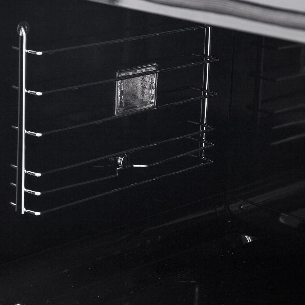 Black electric wall oven with chrome wire rack and interior side rails