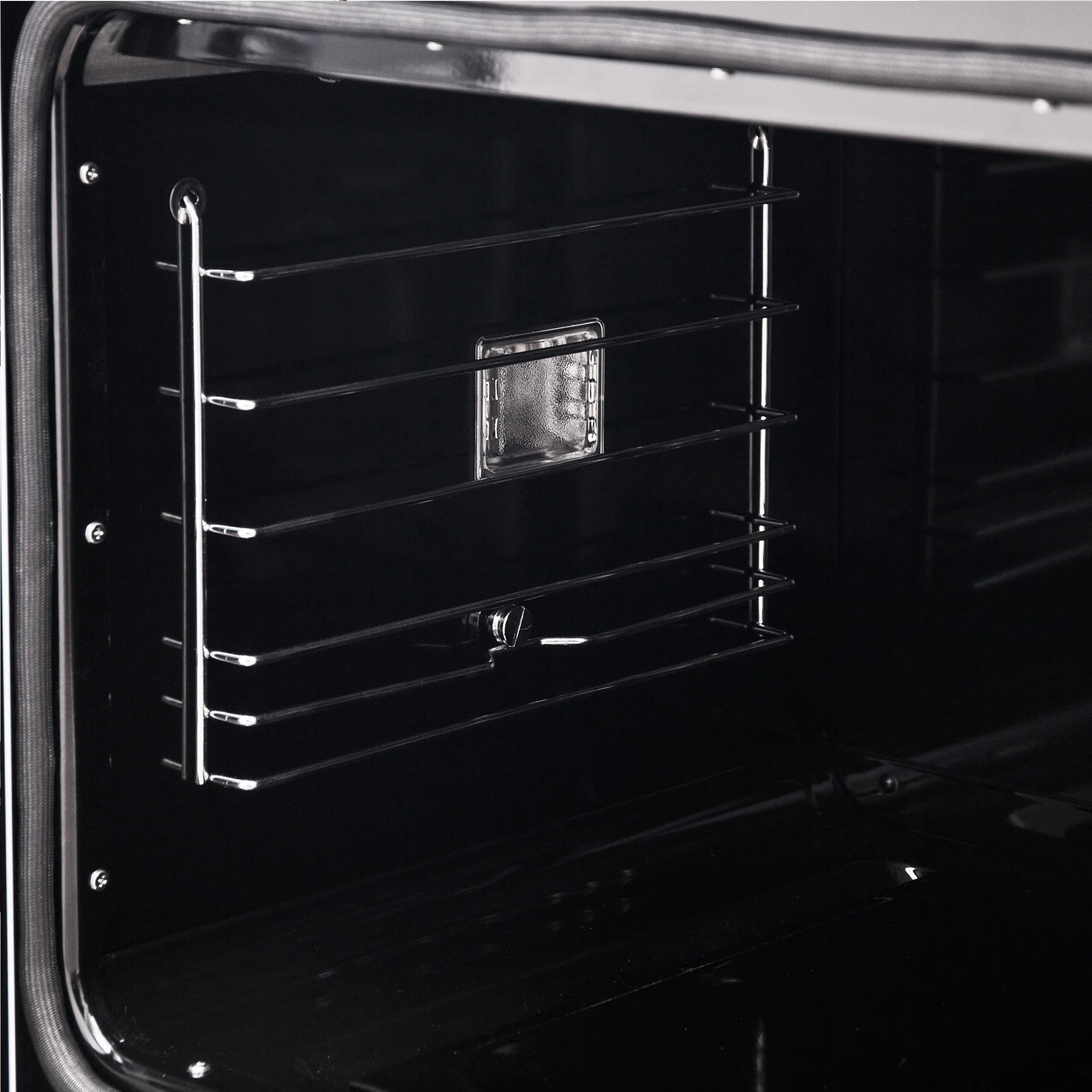 French door wall oven interior with black glass door and wire oven racks
