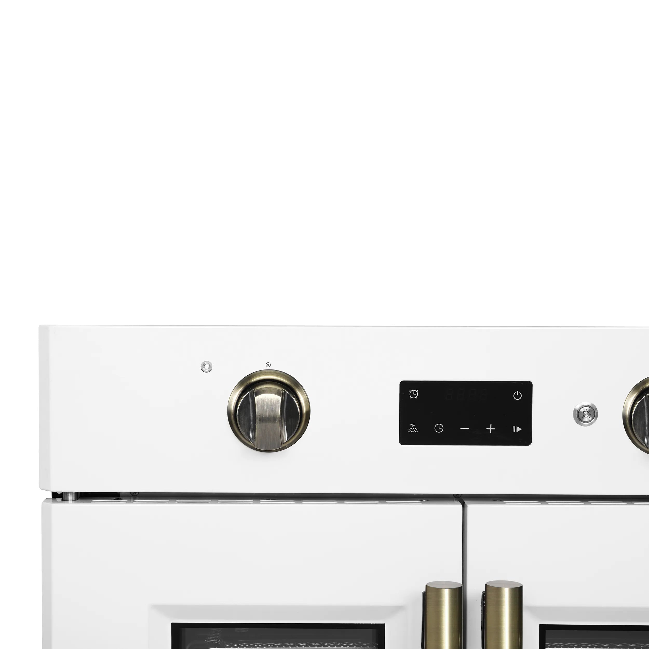 White wall oven control area with two brass knobs and digital display