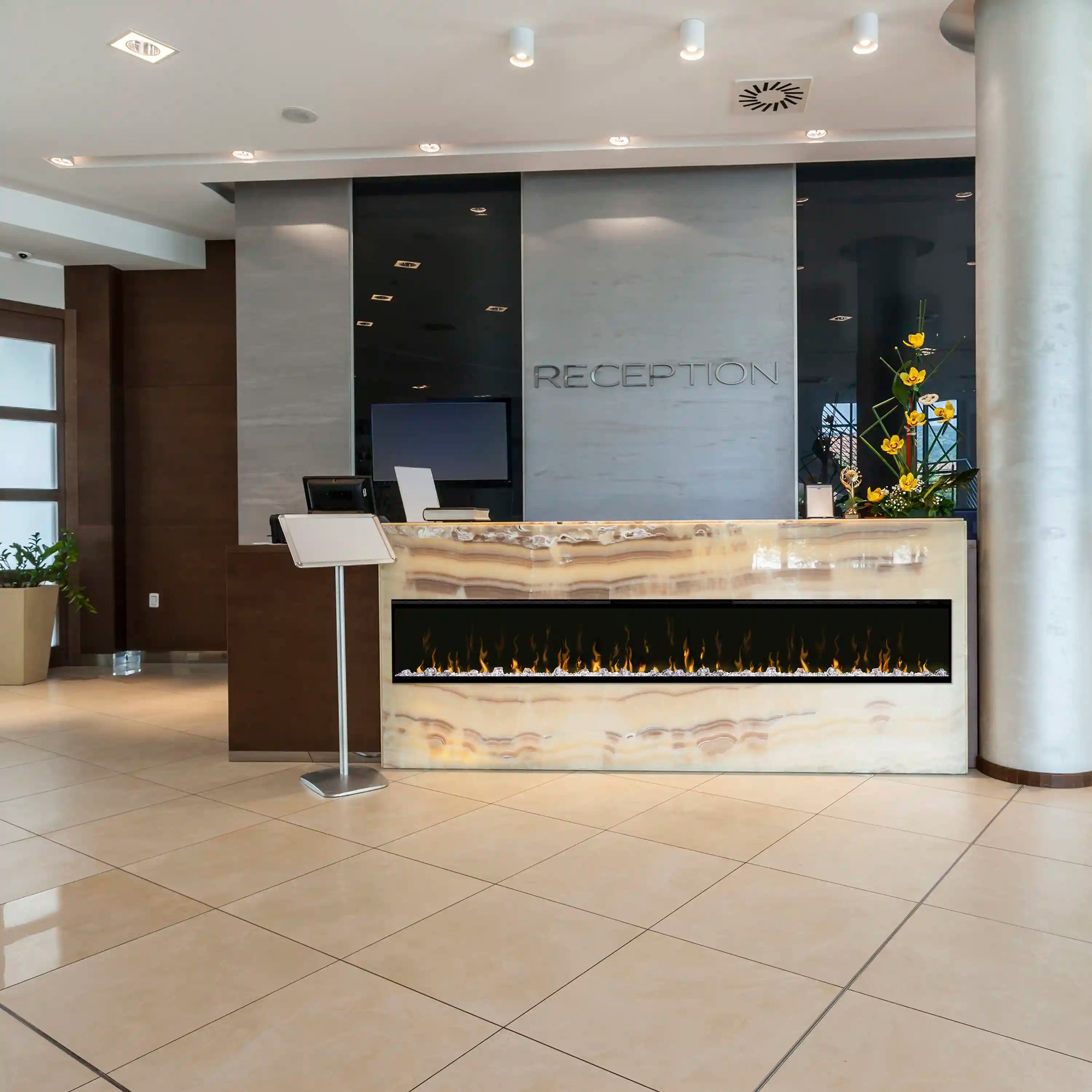 Built-in linear electric fireplace with orange flame display and black surround