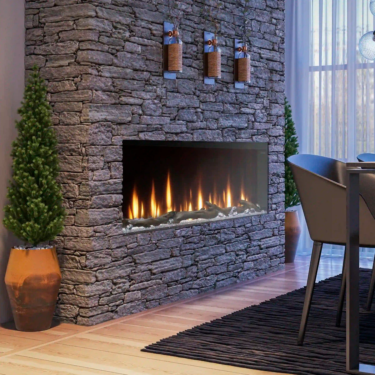Built-in linear electric fireplace set in gray stone wall with glowing flame bed