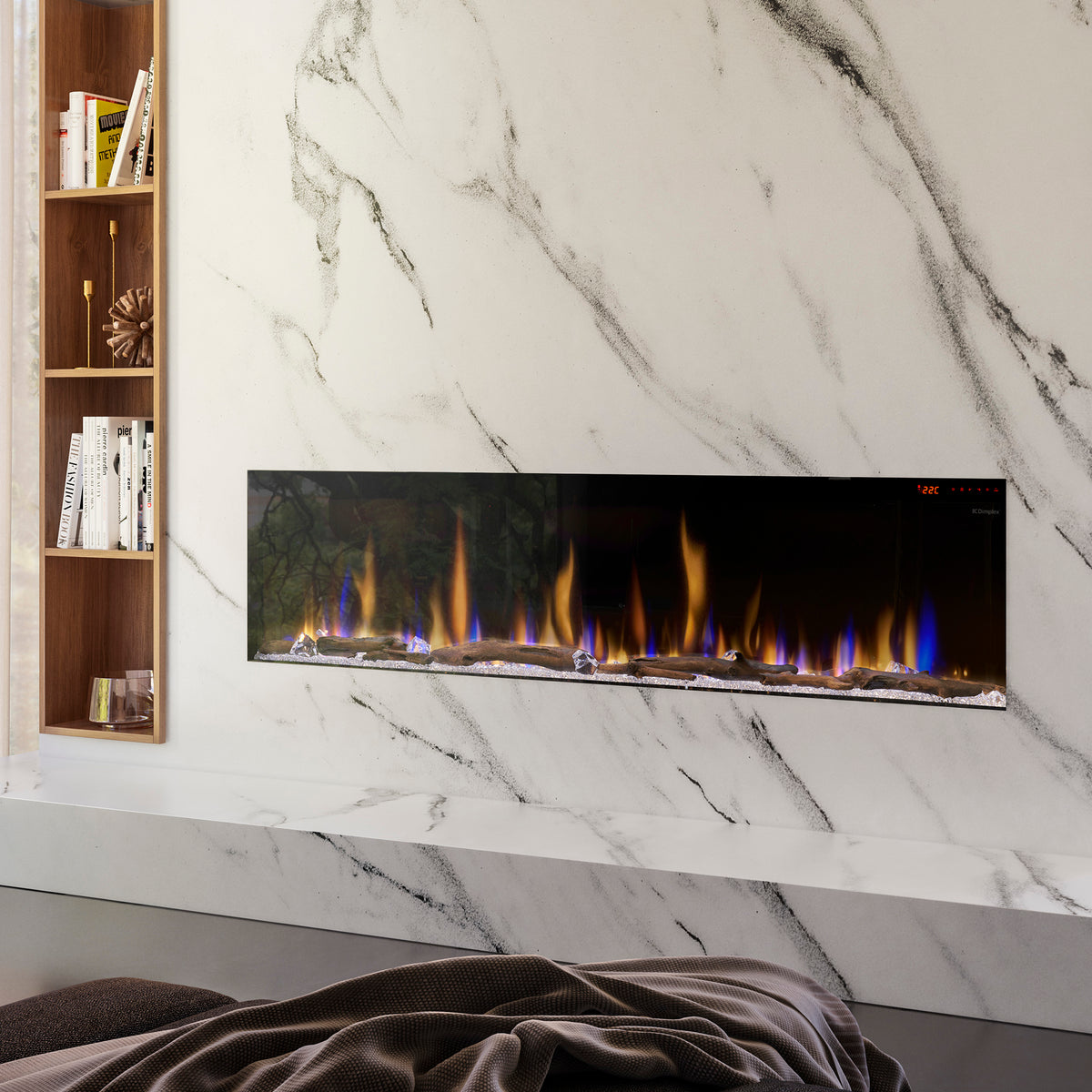 Built-in linear electric fireplace set into a white marble wall surround