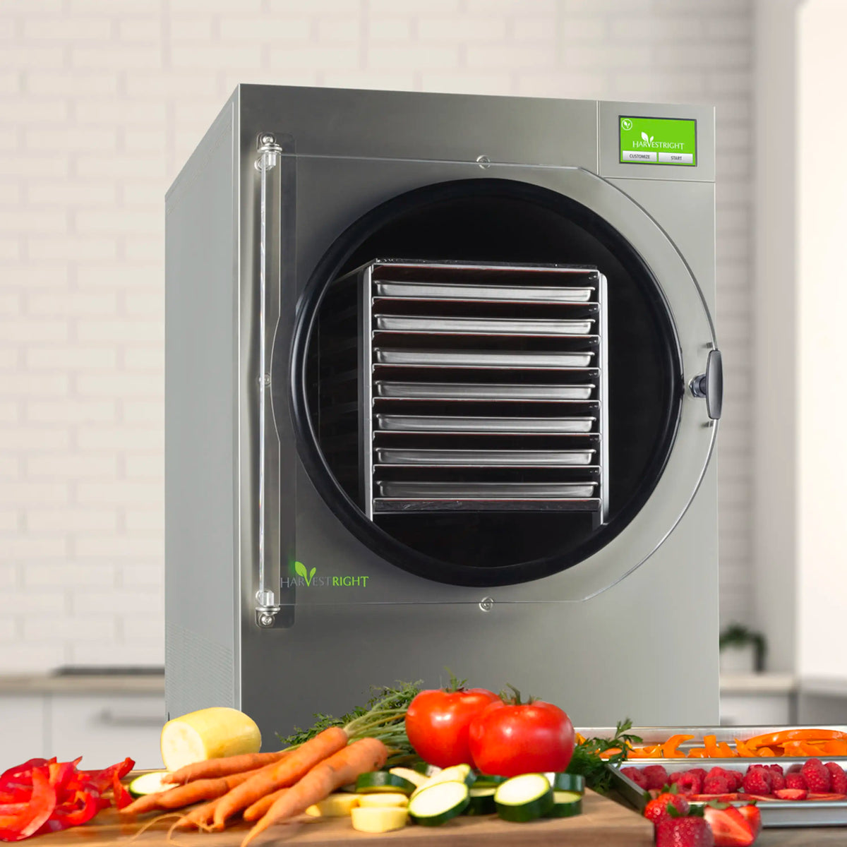 Stainless steel freeze dryer with round door and vented racks, with prepared food items