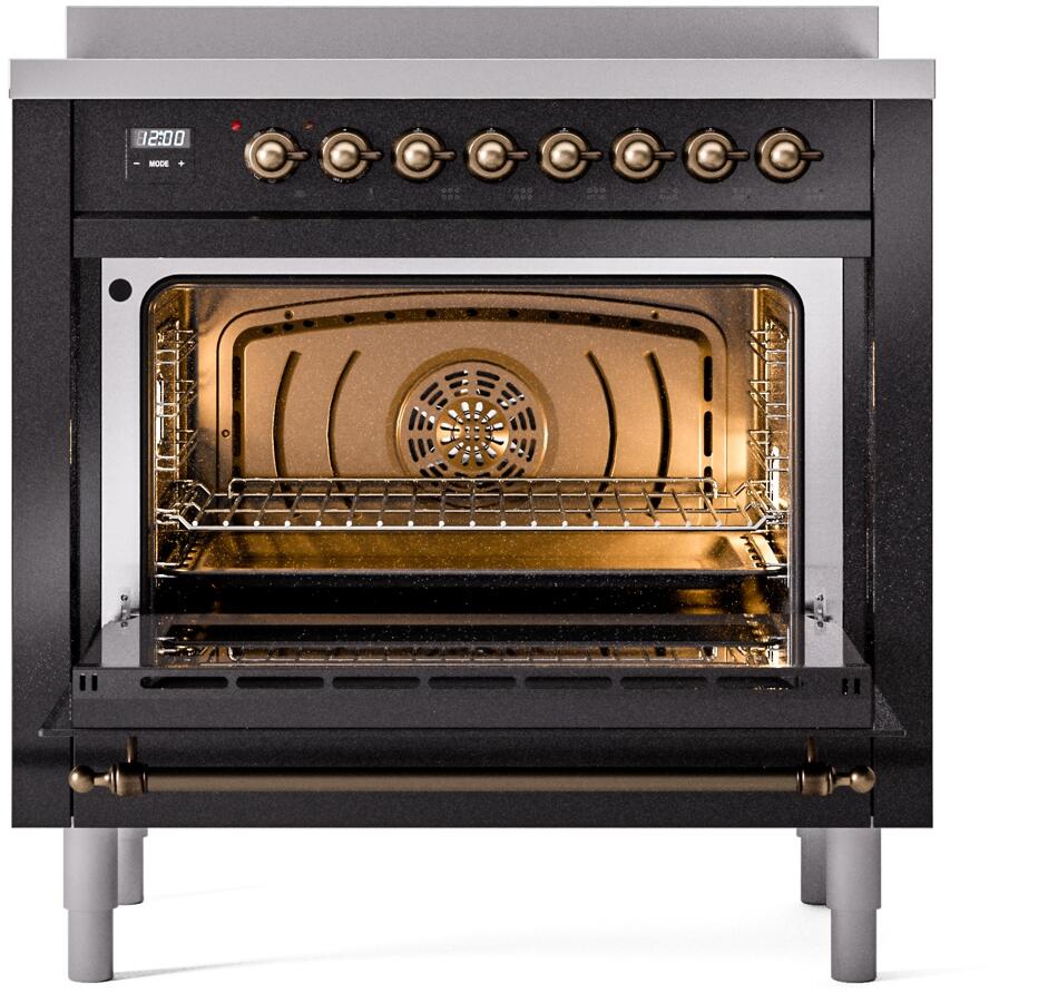 Freestanding electric induction range oven door open with illuminated interior and racks