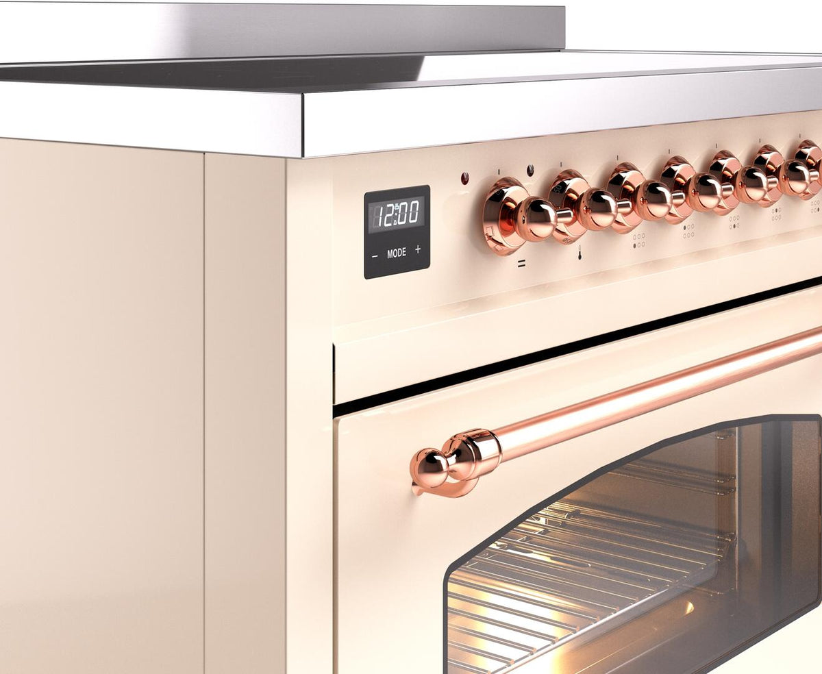 Copper control knobs and digital clock on an antique white electric induction range