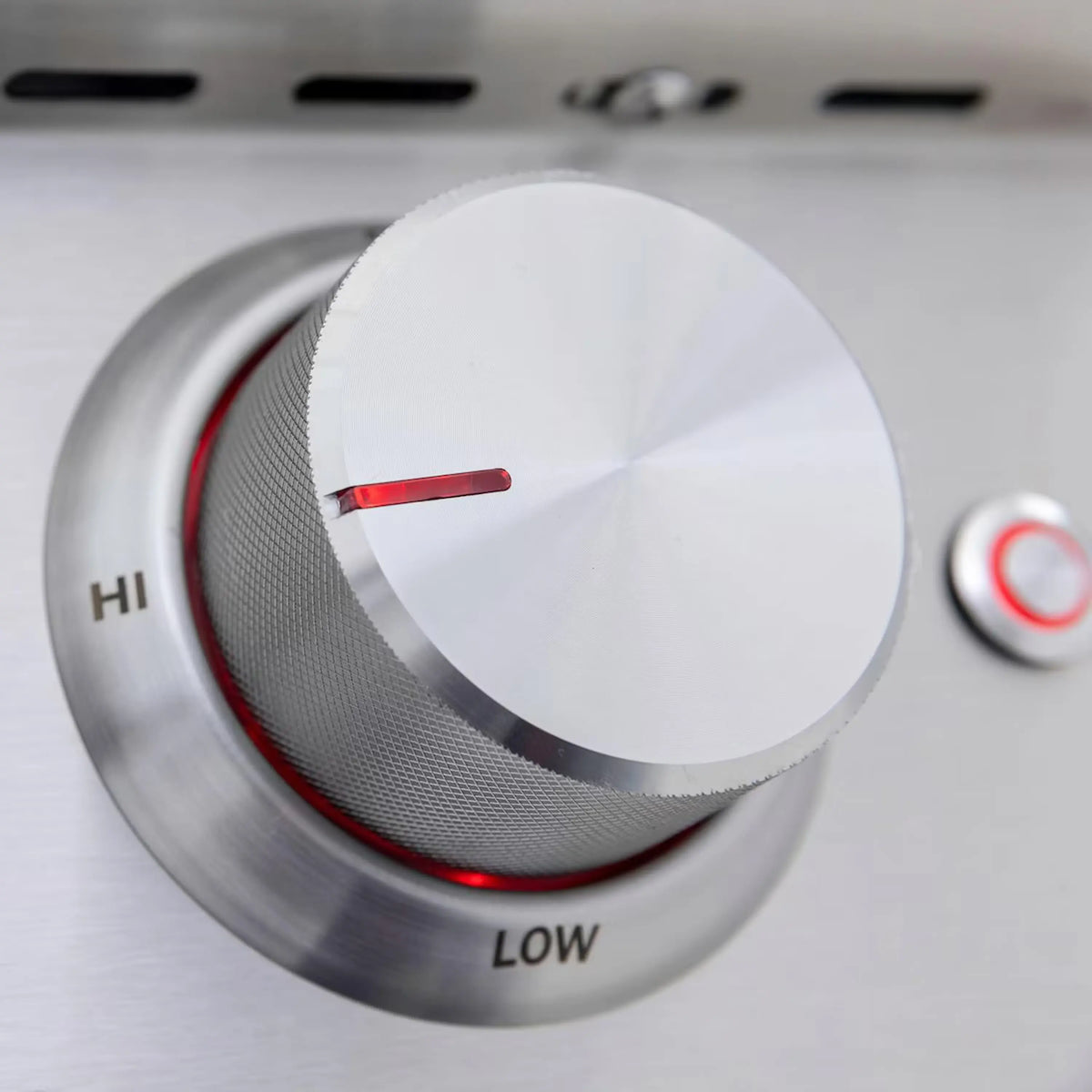 Stainless steel burner control knob set to HIGH with red indicator bar