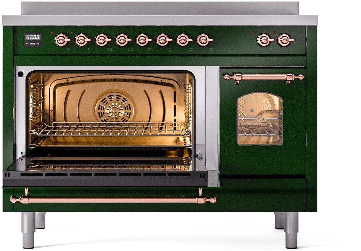 Emerald green induction range with oven open, lit interior, and copper front handle