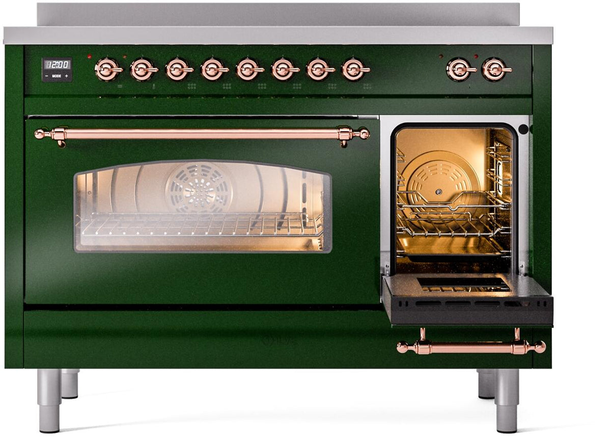 Emerald green freestanding range with open oven and lit fan, copper trim and handle