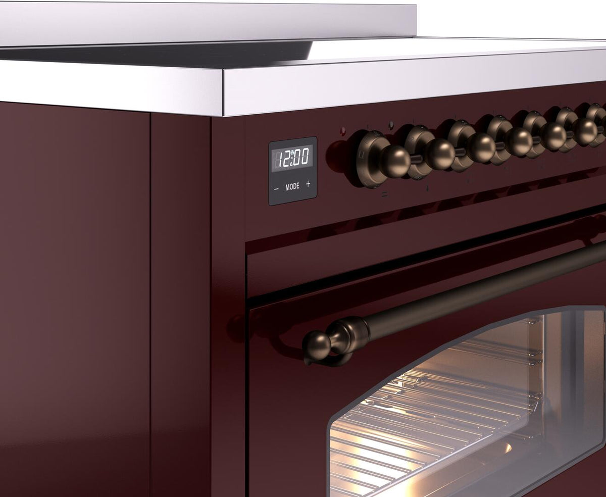 Freestanding induction range control panel with 12:00 display and bronze knobs