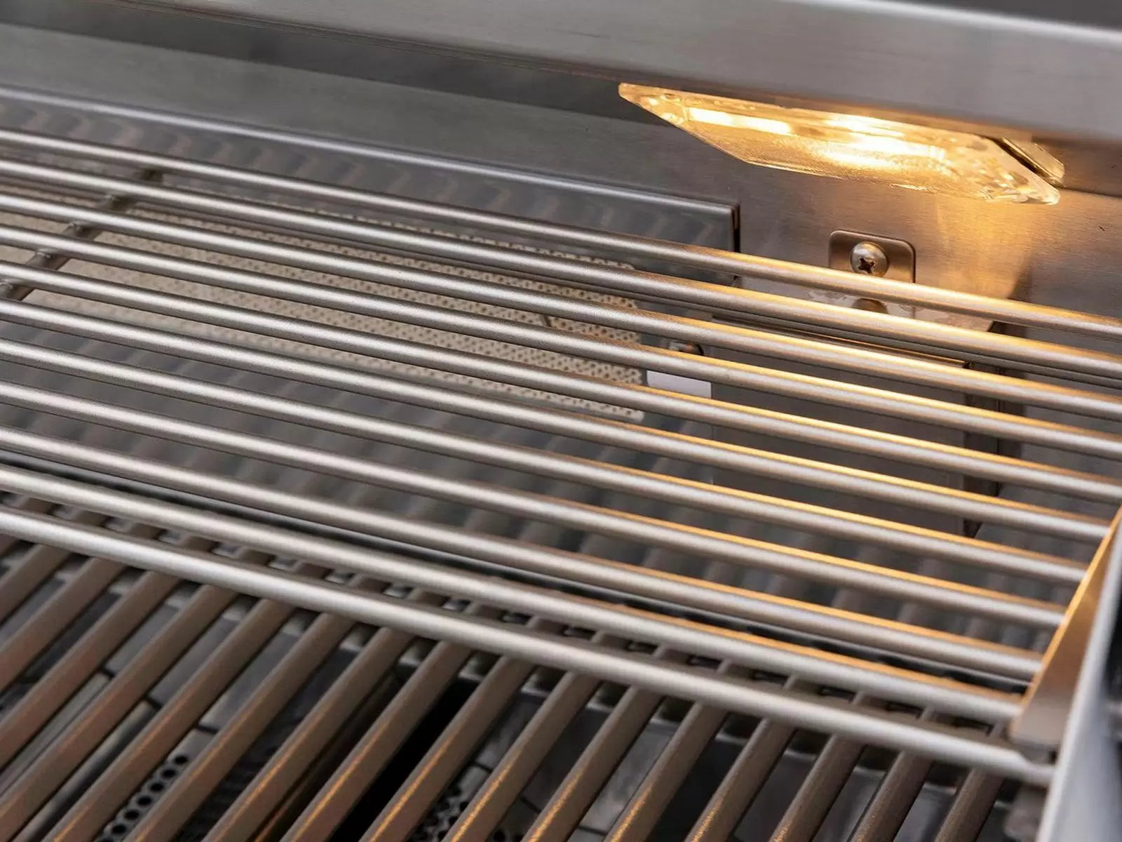 Infrared burner glow beneath stainless grill grates