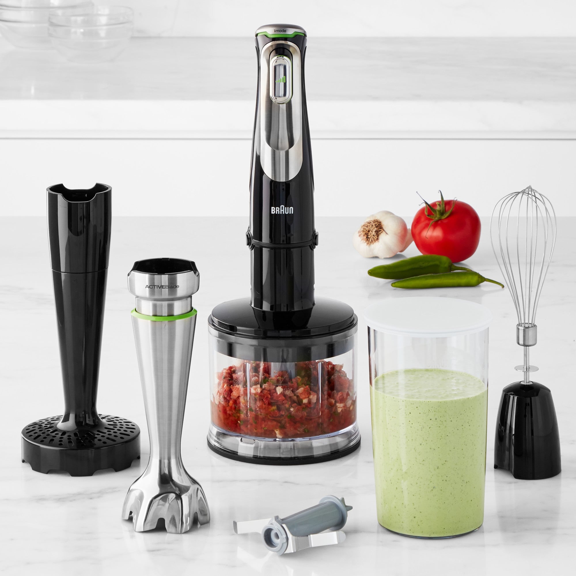 Braun hand blender with multiple attachments, including whisk, chopper, and blending cup.