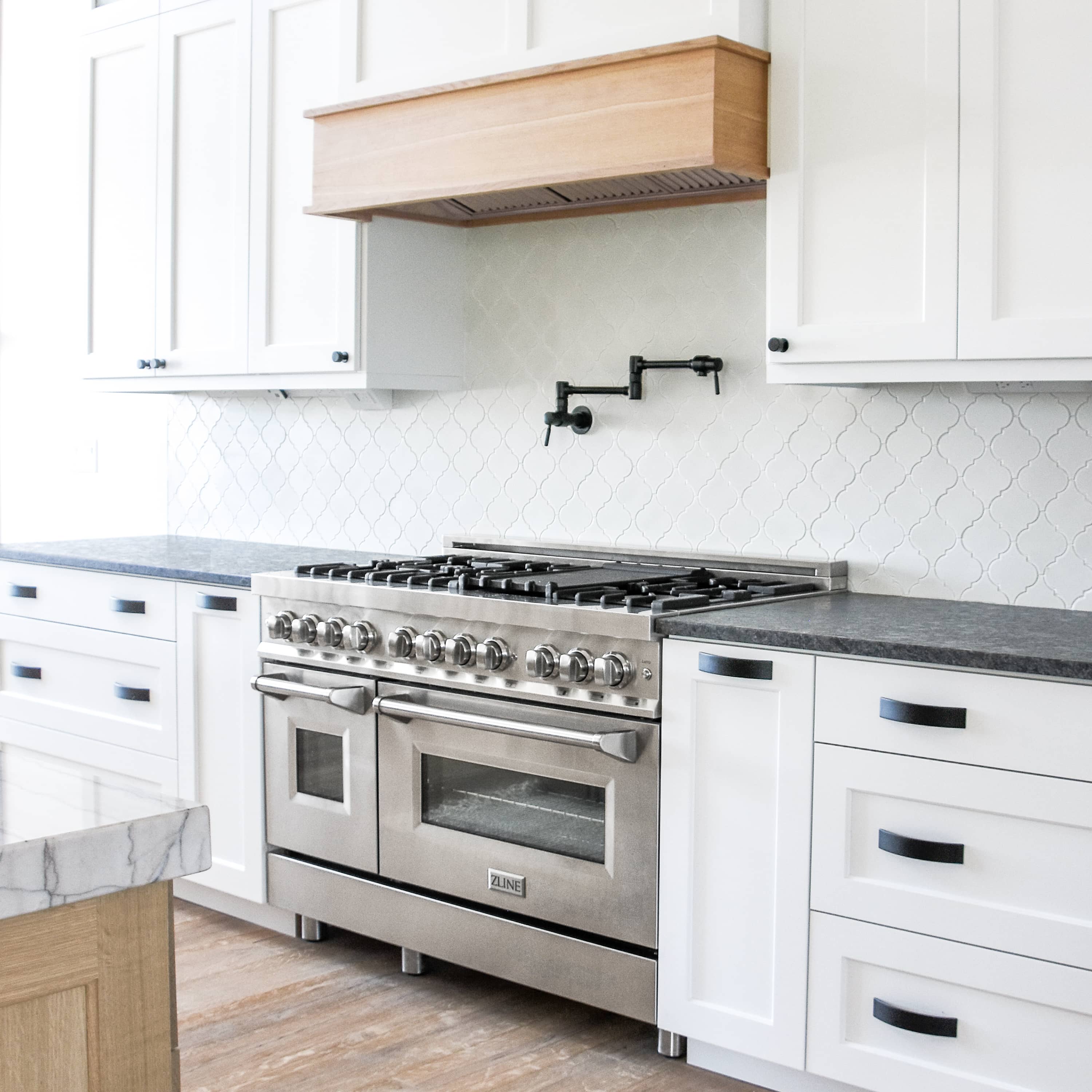 Stainless steel dual fuel range with gas burners and two oven doors in kitchen