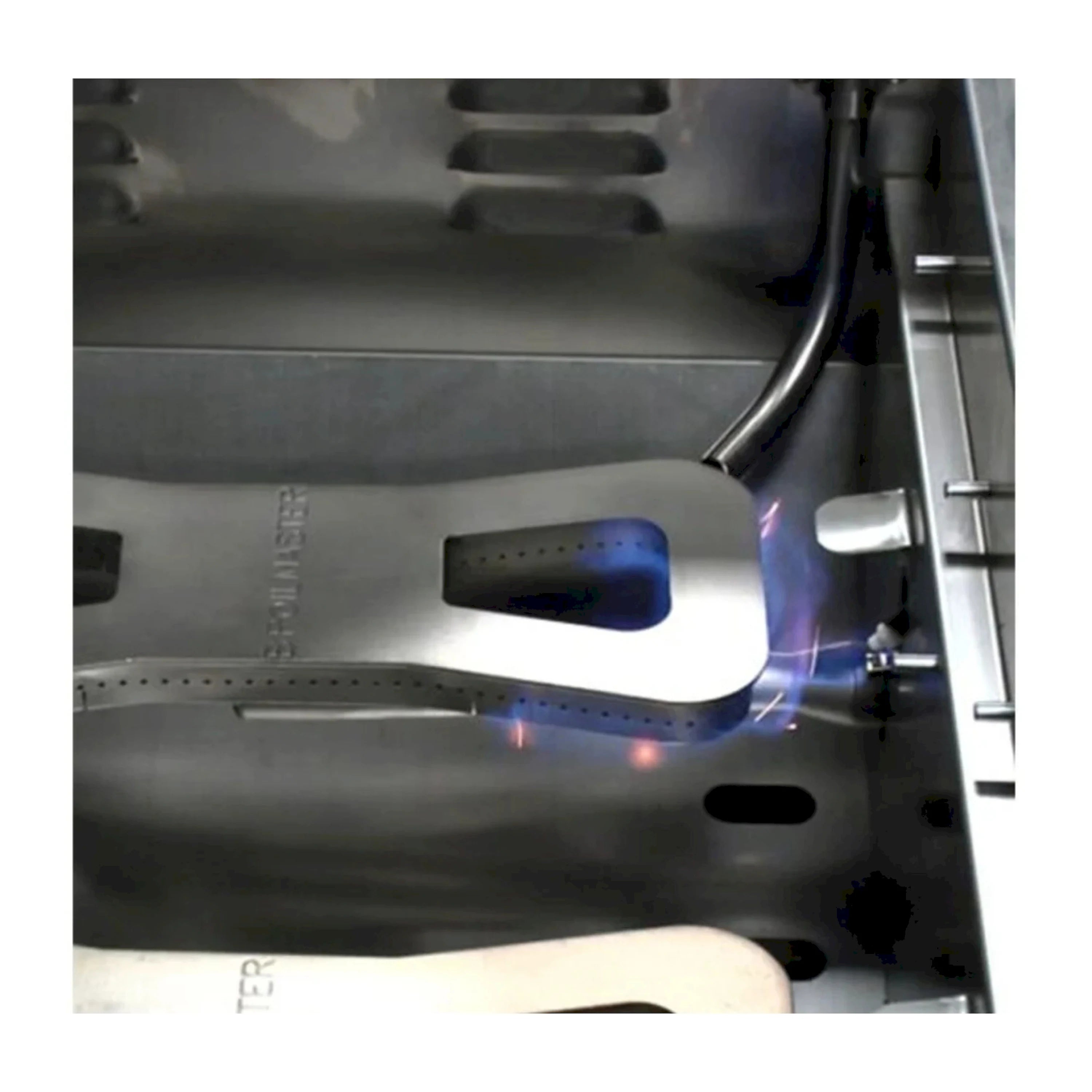 Stainless steel natural gas griddle burner area with visible blue flames and controls