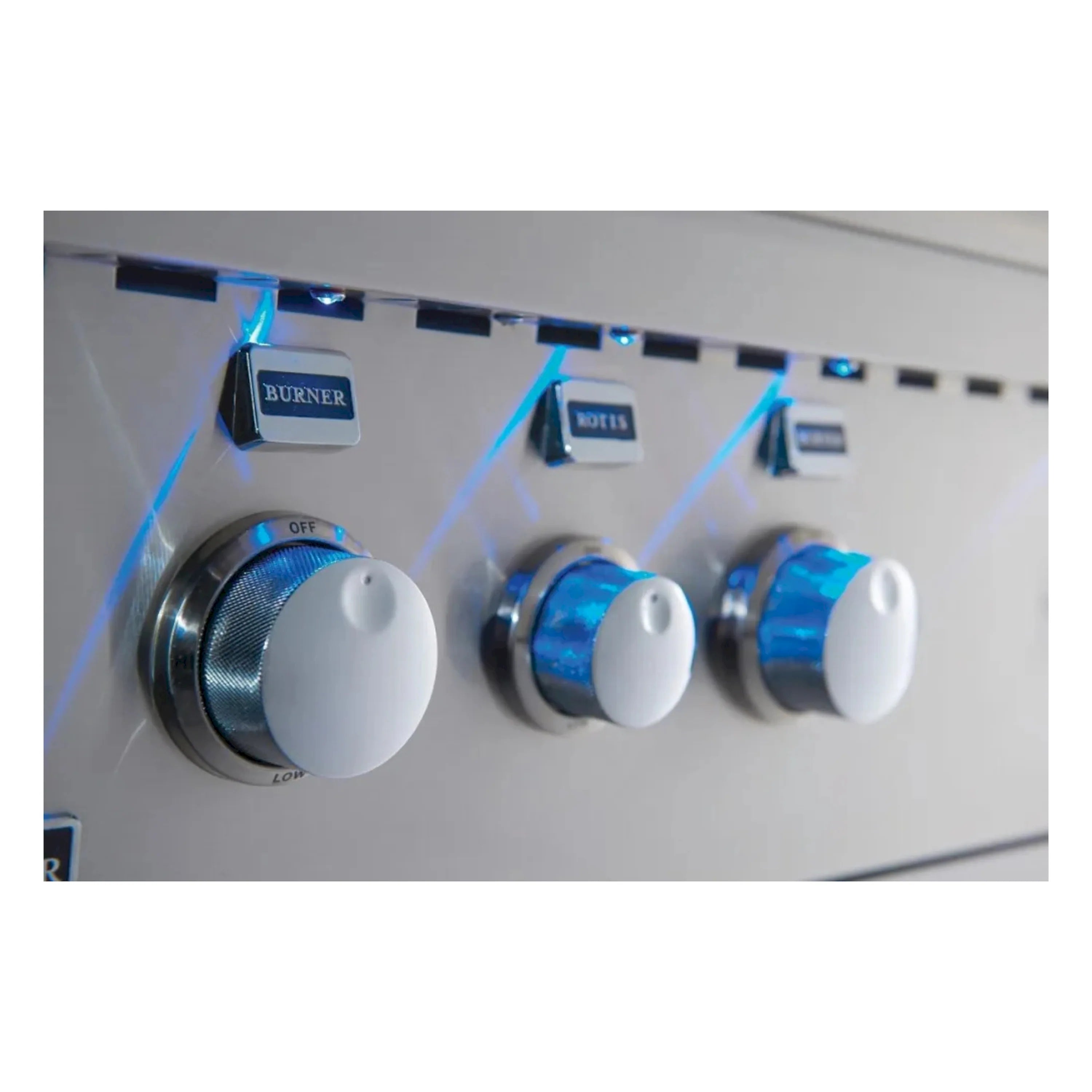 Stainless steel control panel with three burner knobs and ignition area