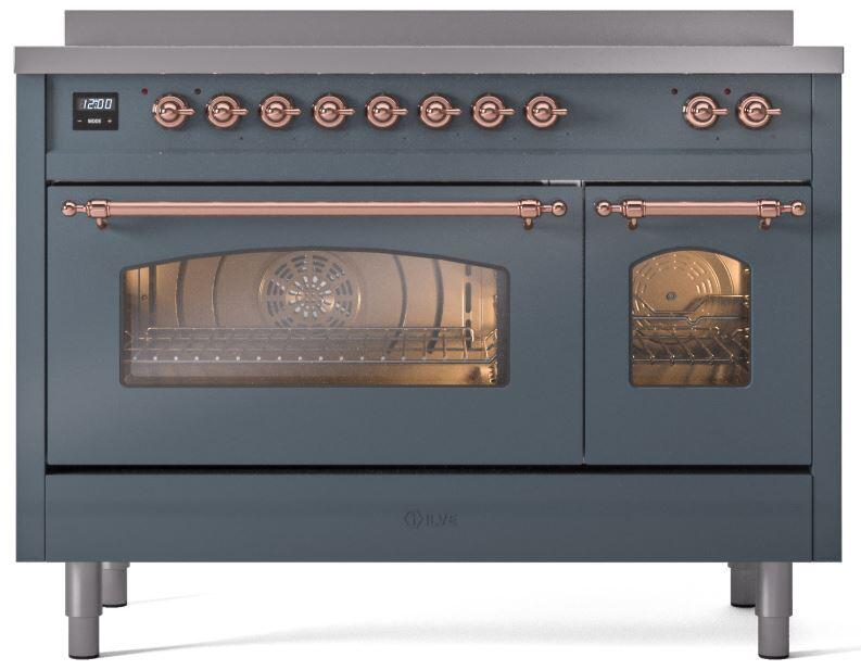 Blue-grey freestanding induction range with copper trim, lit oven window, and closed right door.