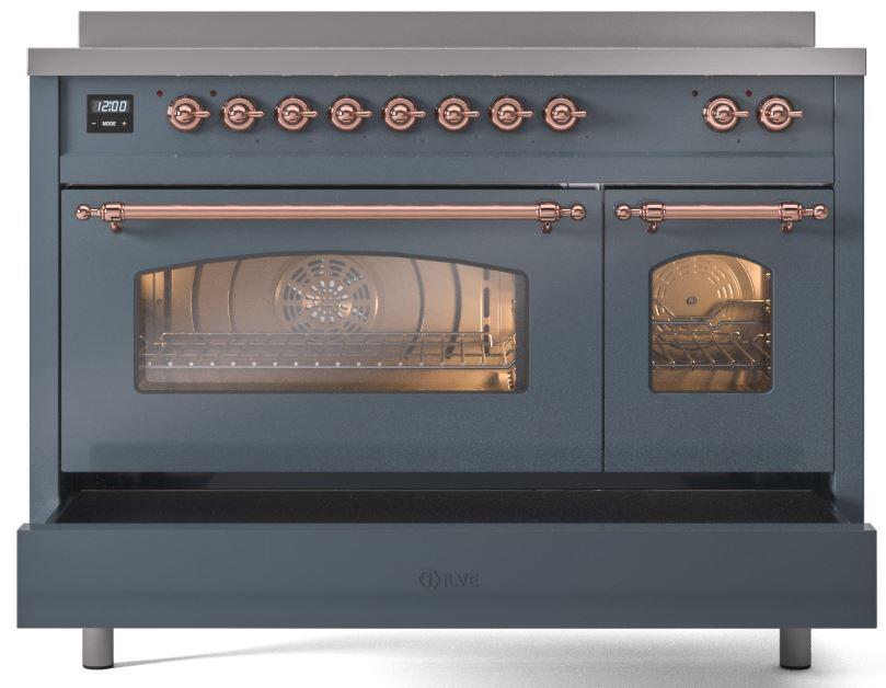 Blue-grey induction range with copper trim, oven window lit, and side oven door closed.