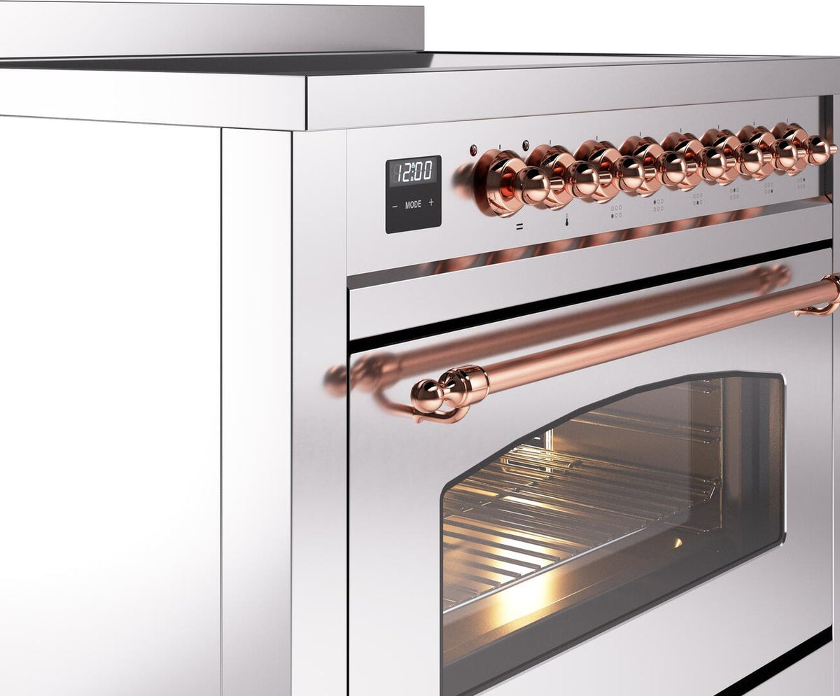 Close-up of copper control knobs and oven handle on a stainless steel range