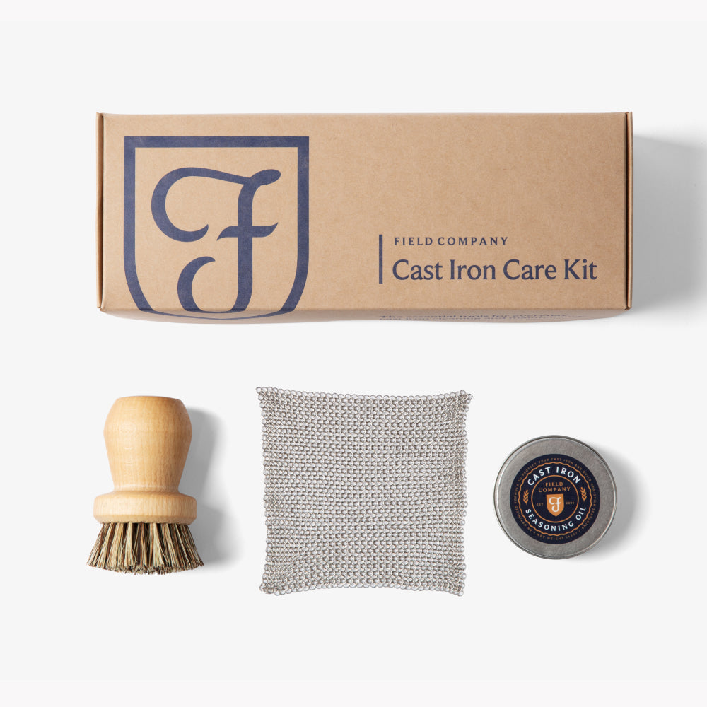 Field Company cast iron care kit box with brush, scrub pad, and seasoning tin