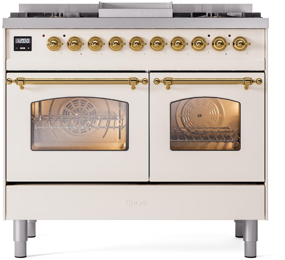 Antique white freestanding range with brass knobs, broiler grates, and oven window doors