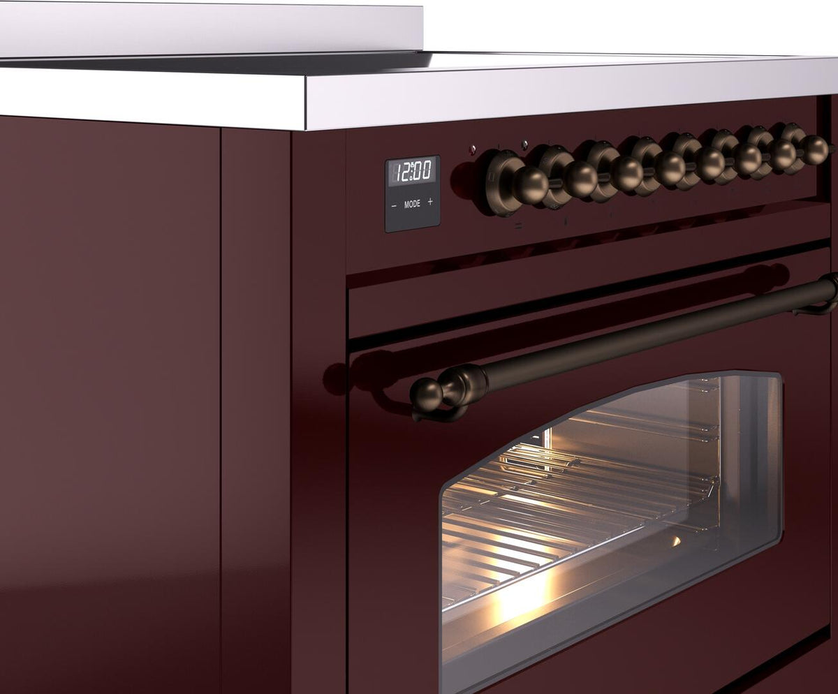 Burgundy electric induction range with bronze knobs, oven handle, and glowing control display